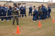 MINOT AIR FORCE BASE, N.D. -- Airmen from the 91st Space Wing participate in a tug-of-war in front of the 91st SW headquarters building here Oct. 12. The 91st SW held various events across the base, as part of its "Wingman Day." The events emphasized teamwork, leadership and the wingman concept. (U.S. Air Force photo by Airman 1st Class Cassandra Jones)