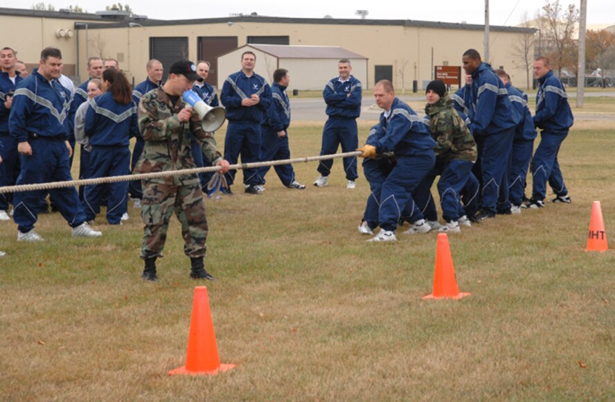 MINOT AIR FORCE BASE, N.D. -- Airmen from the 91st Space Wing participate in a tug-of-war in front of the 91st SW headquarters building here Oct. 12. The 91st SW held various events across the base, as part of its "Wingman Day." The events emphasized teamwork, leadership and the wingman concept. (U.S. Air Force photo by Airman 1st Class Cassandra Jones)