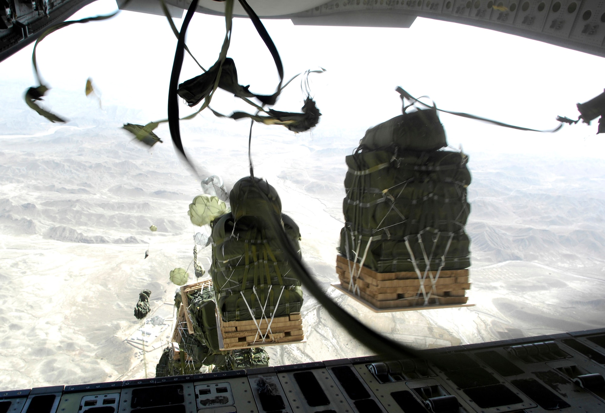 On the first pass, 16 resupply bundles are dropped from the lead C-17 Globemaster III onto a drop zone in Afghanistan Oct. 11.  A total of 62 cargo bundles were dropped from two C-17s.  This was the first time a combat cargo drop of this magnitude has taken place from two C-17s in formation over one drop zone.  The planes and crews are from the 817th Expeditionary Airlift Squadron at Manas, Kyrgyzstan. (U.S. Air Force photo/Staff Sgt. Brian Ferguson)