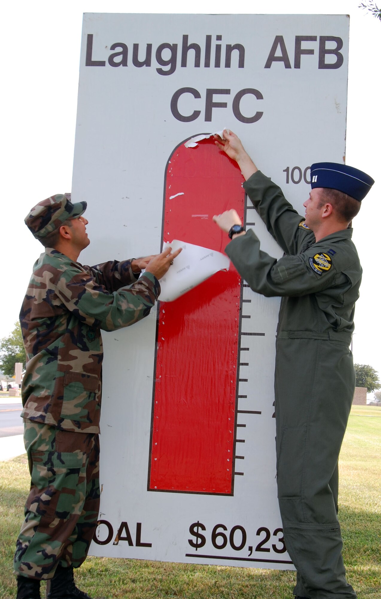 LAUGHLIN AIR FORCE BASE, Texas -- 1st. Lt. Eric Alonso-Bernal, 47th Contracting Squadron, and Capt. Nate Cook , 85th Flying Training Wing, tear off the last part of the Combined Federal Campaign chart to reveal the 100 percent goal Laughlin reached last week. "We smashed our goal of $60,230, and we?re currently at 113 percent all thanks to the amazing generosity of the Laughlin members," said Captain Cook. "Last year we reached nearly $100,000, this campaign ha the potential to reach the same." Laughlin's CFC will be excepting donations until Oct. 26, contact your CFC representative to make your donation. (U.S. Air Force photo by Airman Sara Csurilla)