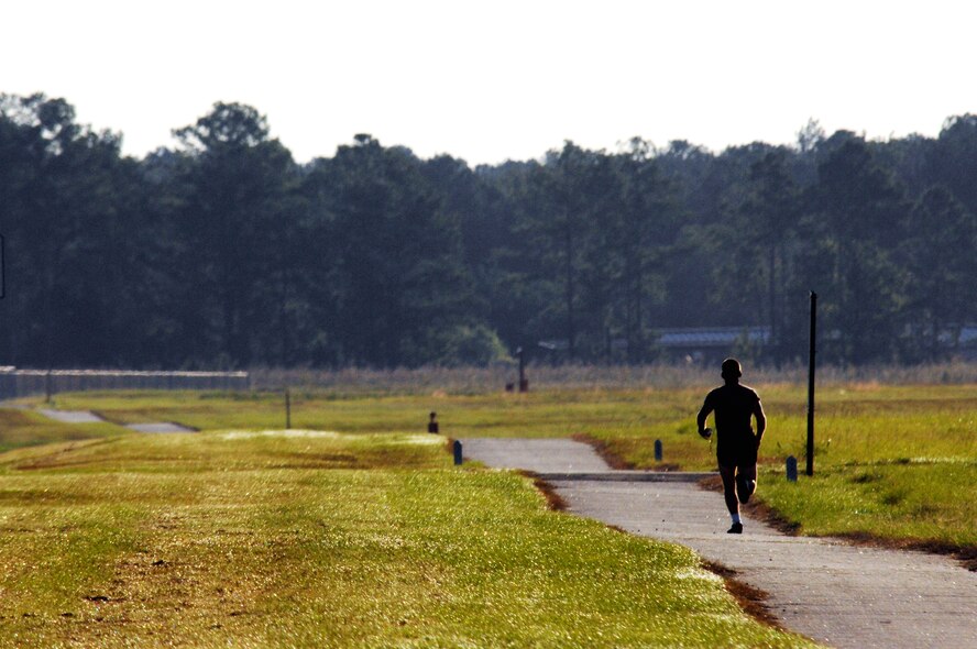 MOODY AIR FORCE BASE, Ga. -- A member of Moody’s 23rd Wing enjoys the cool fall temperatures while jogging along the inner perimeter of the base during a morning physical training session Oct.11.  Physical training is a key component to the wing’s mission readiness goals. (U. S. Air Force photo by Tech. Sgt. Jeffrey Allen)