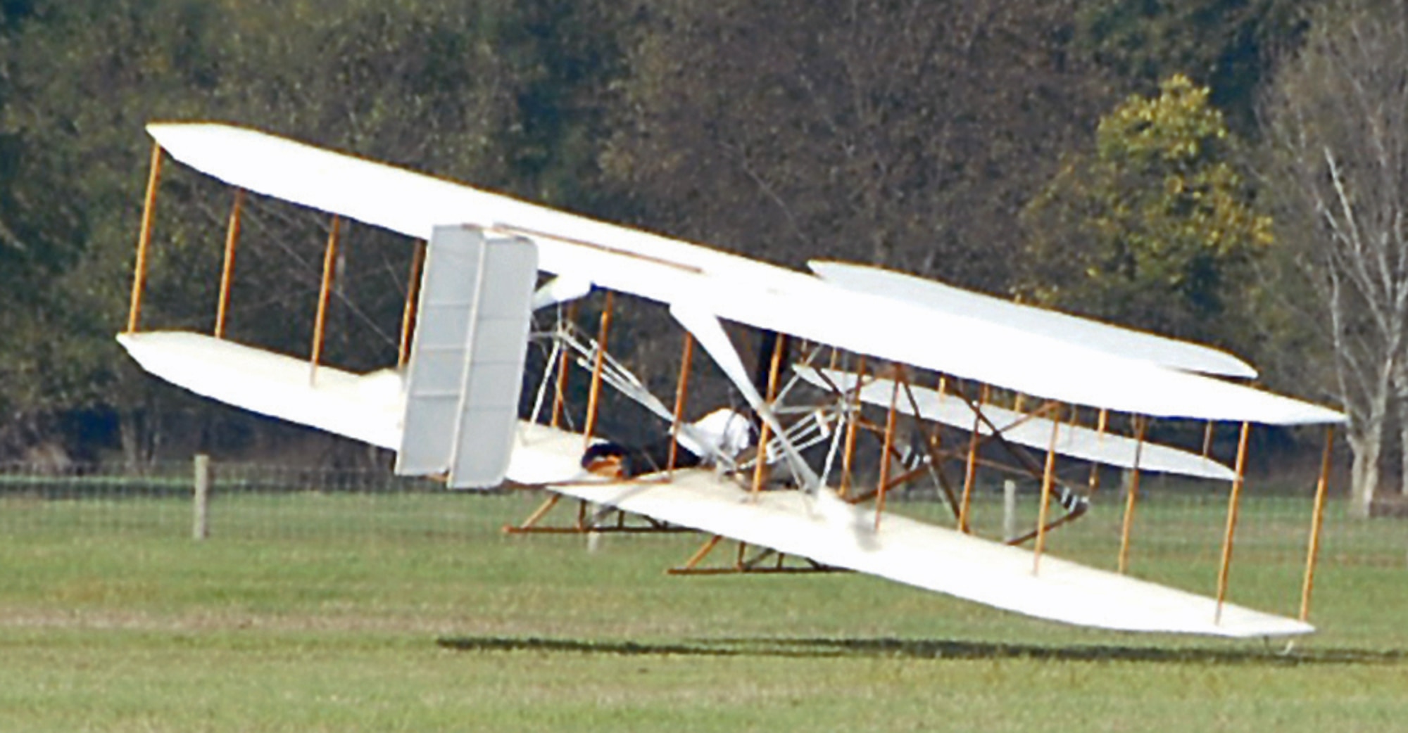 Mark Dusenberry pilots a replica Wright Flyer III he built over Huffman Prairie at Wright-Patterson Air Force Base on Oct. 5.  Dusenberry was reenacting a record breaking flight at the same location 102 years earlier, when Wilbur Wright circled the field for 39 minutes. Dusenberry clipped a wing during a turn about 40 seconds into his flight, damaging both propellers and the undercarriage.  Dusenberry was unhurt and said he plans to repair the aircraft to fly again.  (Skywrighter photo by Christy Web)