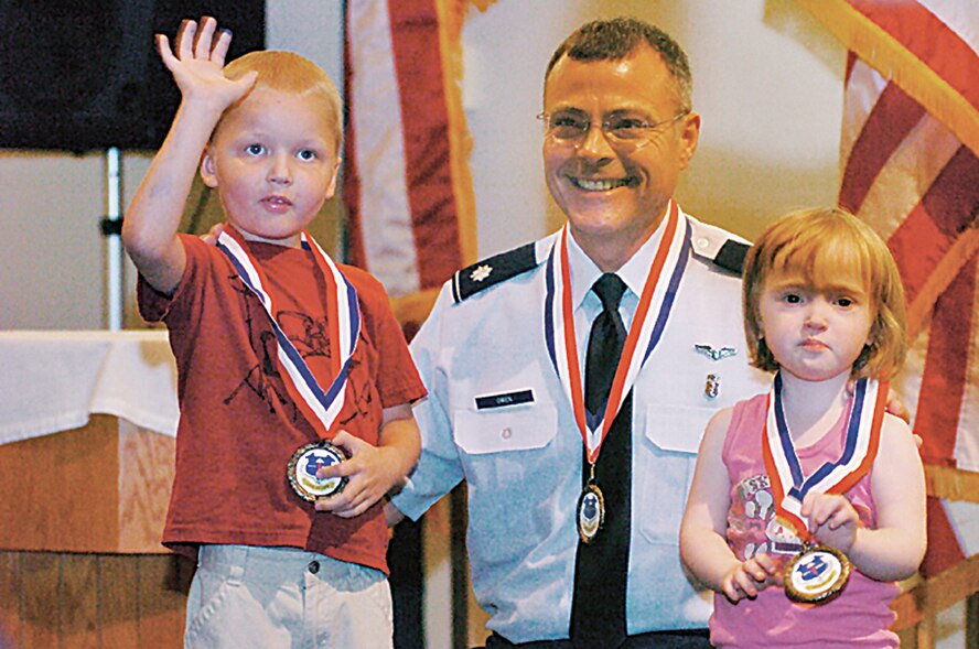 Wright-Patterson Air Force Base Young Heroes Association representative, Lt. Col. Rory Owen, presented Timothy Desmond Kingston and his sister Ada Lillian Kingston with Young Heroes Medals of Honor during a base ceremony on Oct. 4. Owen was also presented an honorary Young Heroes Medal. (Skywrighter photo/Charles Caperton)