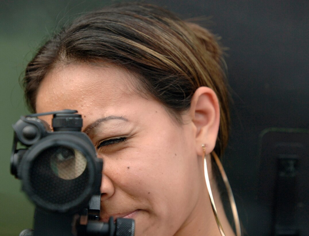 Marietta High School student Lizbeth Juarez looks through the scope of a M4 Carbine rifle during an Air Force Week Atlanta event at Marietta High School Oct. 9 in Marietta, Ga. The event helped to educate students about the U.S. Air Force. (U.S. Air Force photo/Staff Sgt. Bennie J. Davis III) 