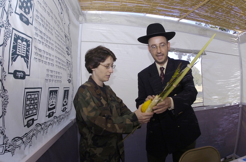 Rabbi (Capt.) Andrew J. Cohen shows Maj. Karen Dacey the purpose of the lulav or palm branch relative to Sukkoth.  Captain Cohen is the new chaplain assigned to the 316th Wing. Major Dacey is assigned to the 79th Surgical Operations Squadron as the officer-in-charge of the Opthomology Clinic.