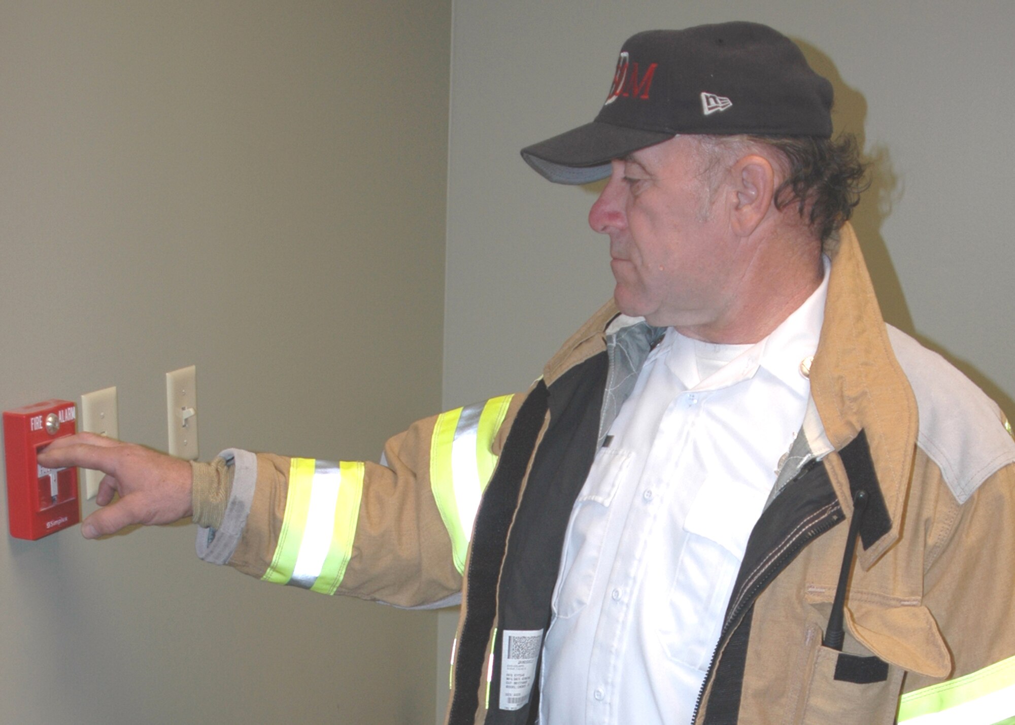 GRISSOM AIR RESERVE BASE, Ind., -- Jim Mock, a fire inspector for the Grissom Fire Department, pulls down the fire alarm to start an evacuation exercise during fire prevention week. Six to eight classes were held throughout the week where people were taught the proper use of fire extinguishers and practiced evacuating buildings.  (U.S. Air Force photo/ SrA Carl Berry)