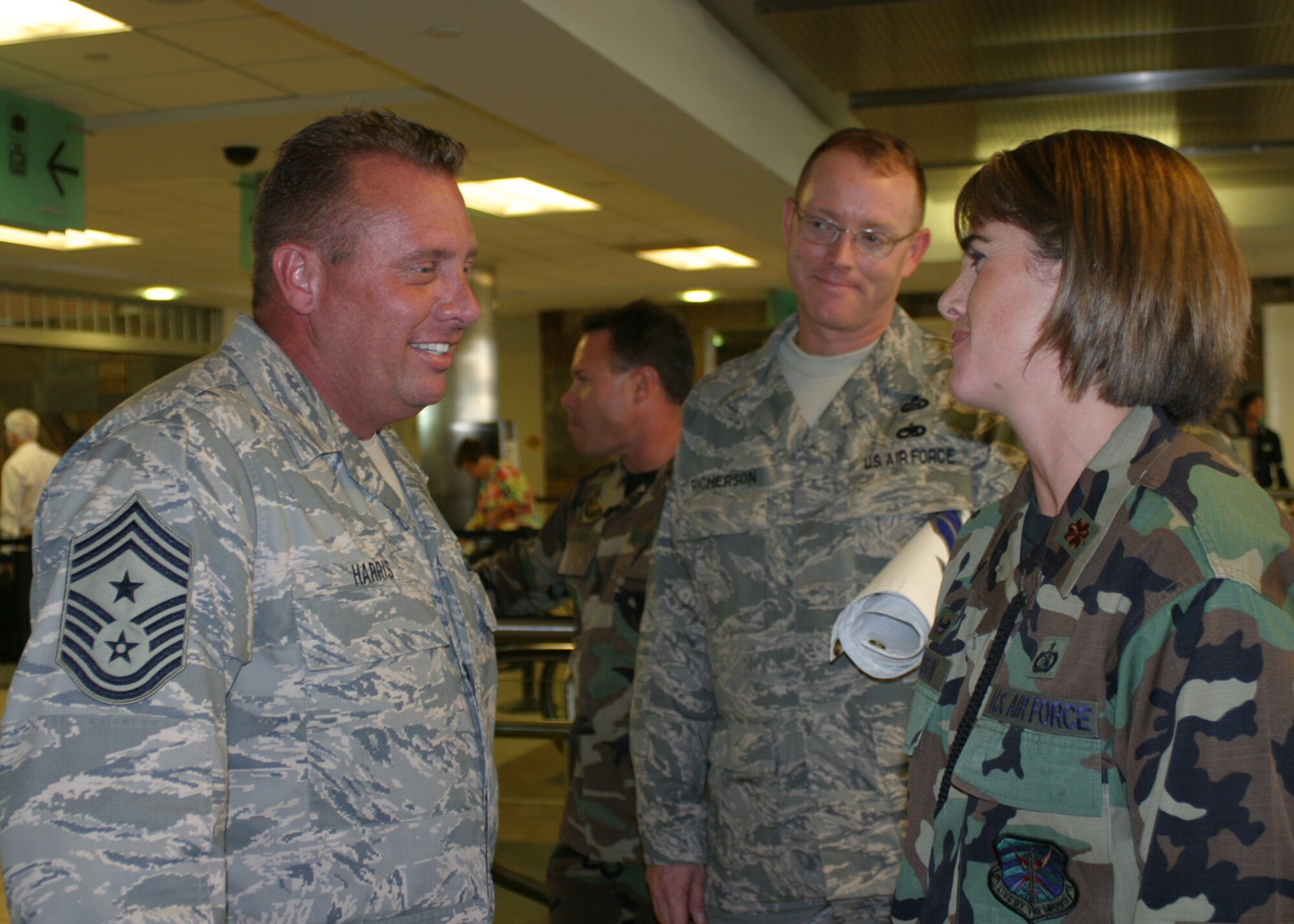 Chief Master Sgt. John R. Harris Jr., formerly the command senior enlisted leader for Combined Joint Task Force ? Horn of Africa, is greeted by Maj. Vanessa Johnson, commander of the 3rd Combat Communications Support Squadron, during his return to Oklahoma City Oct. 3.  Photo by 2nd Lt. Kinder Blacke