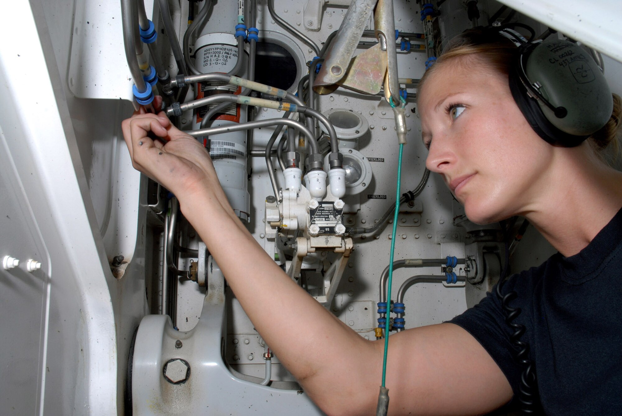 Staff Sgt. Sarah Hall inspects fittings in the nose wheel well of a C-17 Globemaster III Oct. 8 to ensure there are no deficiencies. Sergeant Hall, deployed from Charleston Air Force Base, S.C., is with the 8th Expeditionary Air Mobility Squadron at a deployed location in Southwest Asia.  (U.S. Air Force photo/Staff Sgt. Douglas C. Olsen)
