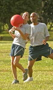 Anthony Mitchell, 437th Airlift Wing, backs up teammate Kasi Fox as she catches the ball for the final out of the 17th Airlift Squadron team during the final game of the kickball tournament Oct. 5.  (U.S. Air Force photo/Staff Sgt. April Quintanilla)