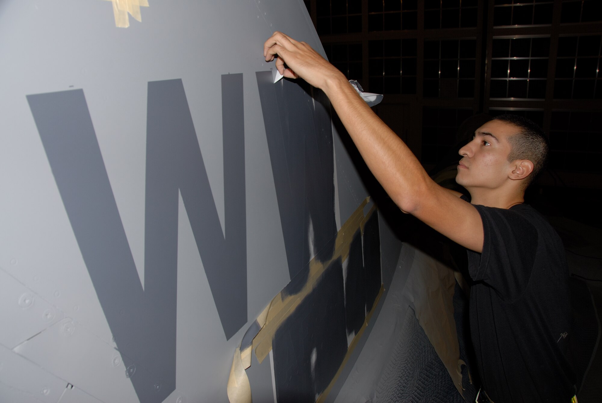 MISAWA AIR BASE, Japan -- Airman 1st Class David Vera, 35th Maintenance Squadron, finalizes the repainting of an F-16 tail wing here on Oct. 12, 2007.  The F-16 was the first of five jets to be re-designated as Wild Weasels after being reassigned from Cannon Air Force Base, N.M.  (U.S. Air Force photo by Senior Airman Laura R. McFarlane)(RELEASED)