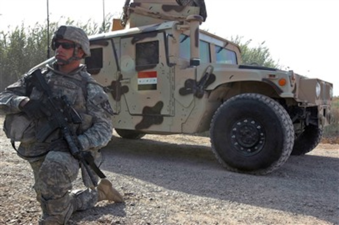 U.S. Army Pvt. Ryan Sullivan provides security as an Iraqi army Humvee vehicle rolls past him in Rawad, Iraq, on Oct. 1, 2007.  Sullivan is assigned as an infantryman with 3rd Platoon, Foxtrot Company, 52nd Infantry Division.  