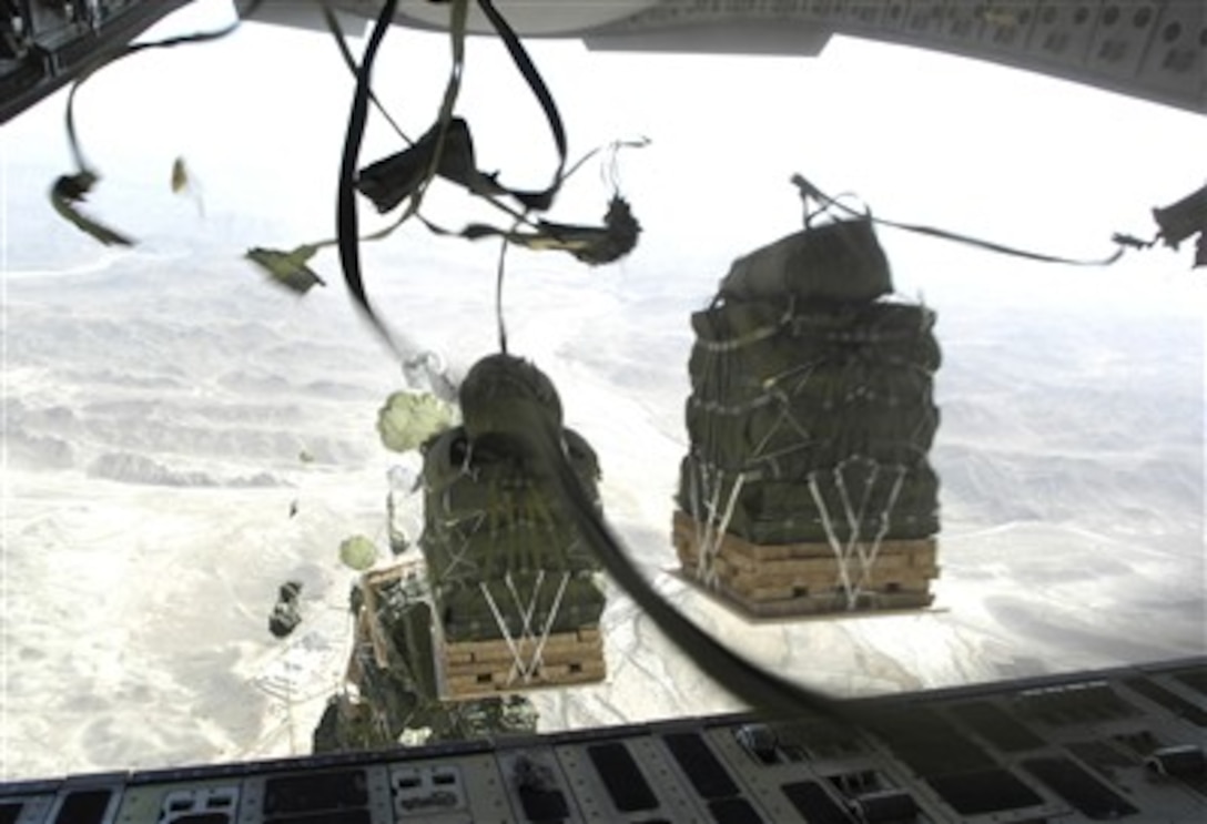 Bundles drop from a C-17 Globemaster III aircraft during a combat cargo drop over a drop zone in Afghanistan on Oct. 11, 2007.  Sixty-two cargo bundles in all were dropped by the flight during the mission.  
