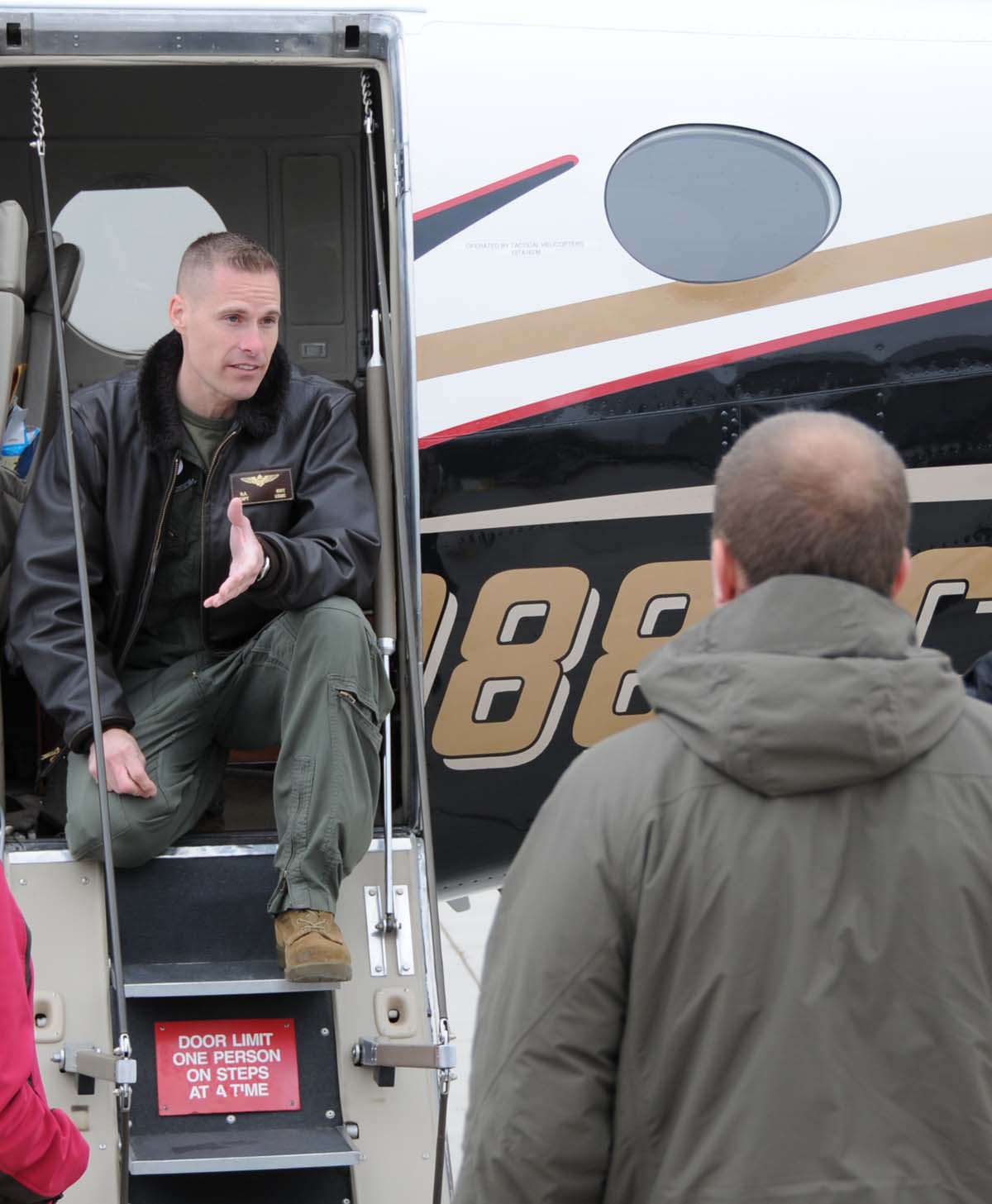 Capt. Richard Birt, the pilot for the 8th Marine Corps District, speaks to the first group of participants for the Marine Corps Flight Orientation Program March 8.  Fifty people participated in the program over the two days at the Rocky Mountain Regional Airport in Broomfield, Colo.
