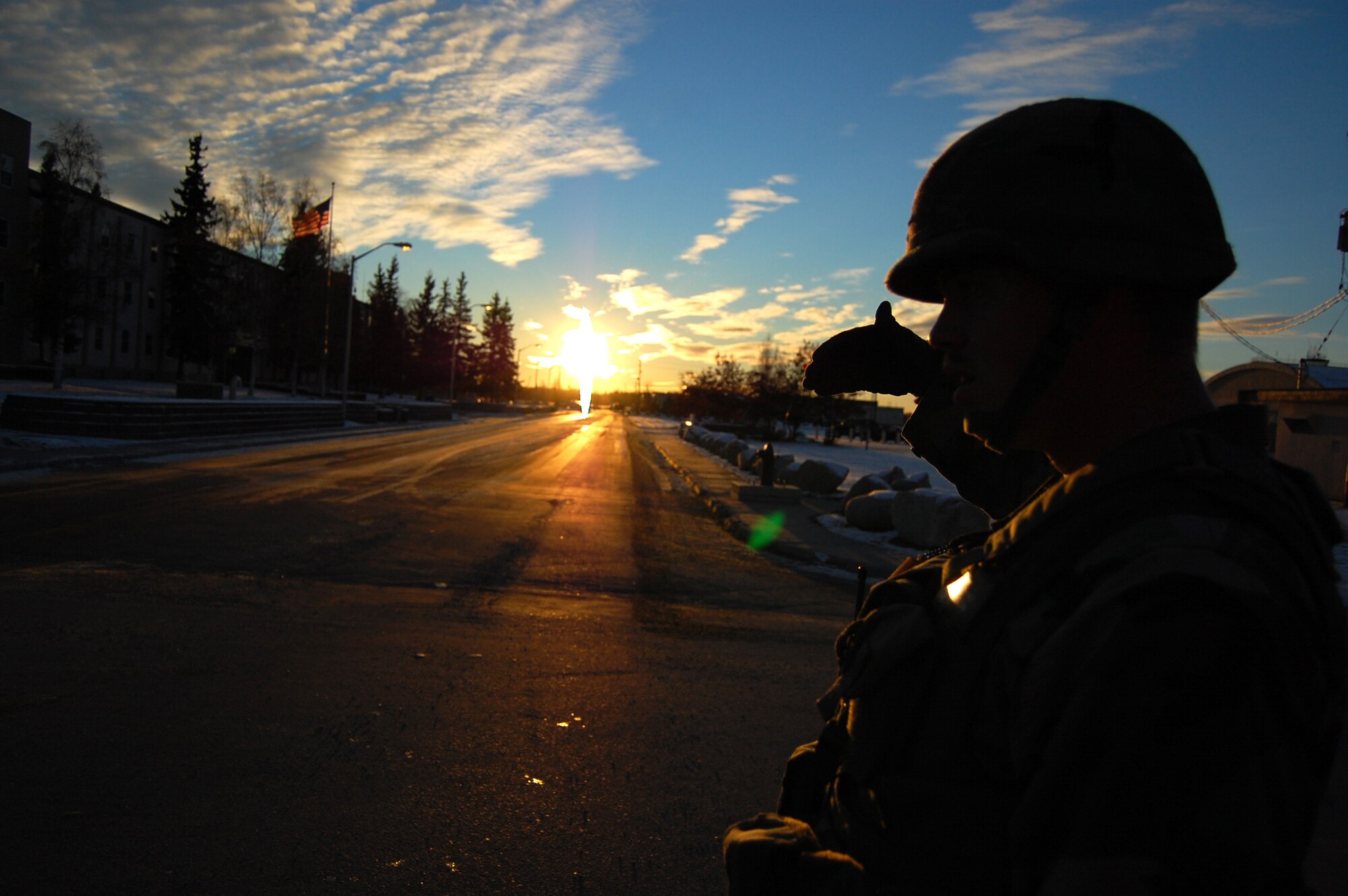 EIELSON AIR FORCE BASE, Alaska --  Staff Sgt. Justin Buchholz, 354th Security Forces Squadron, protects his eyes from the setting Alaskan sun while scanning the area Oct. 12, 2007. Eielson perfeormed an Operational Readiness Exercise Oct. 11 to 14, which contained a variety of scenarios and is employed to ensure Airmen are ready to mobilize at a moments notice when its nation calls. (U.S. Air Force photo by Airman 1st Class Christopher Griffin)