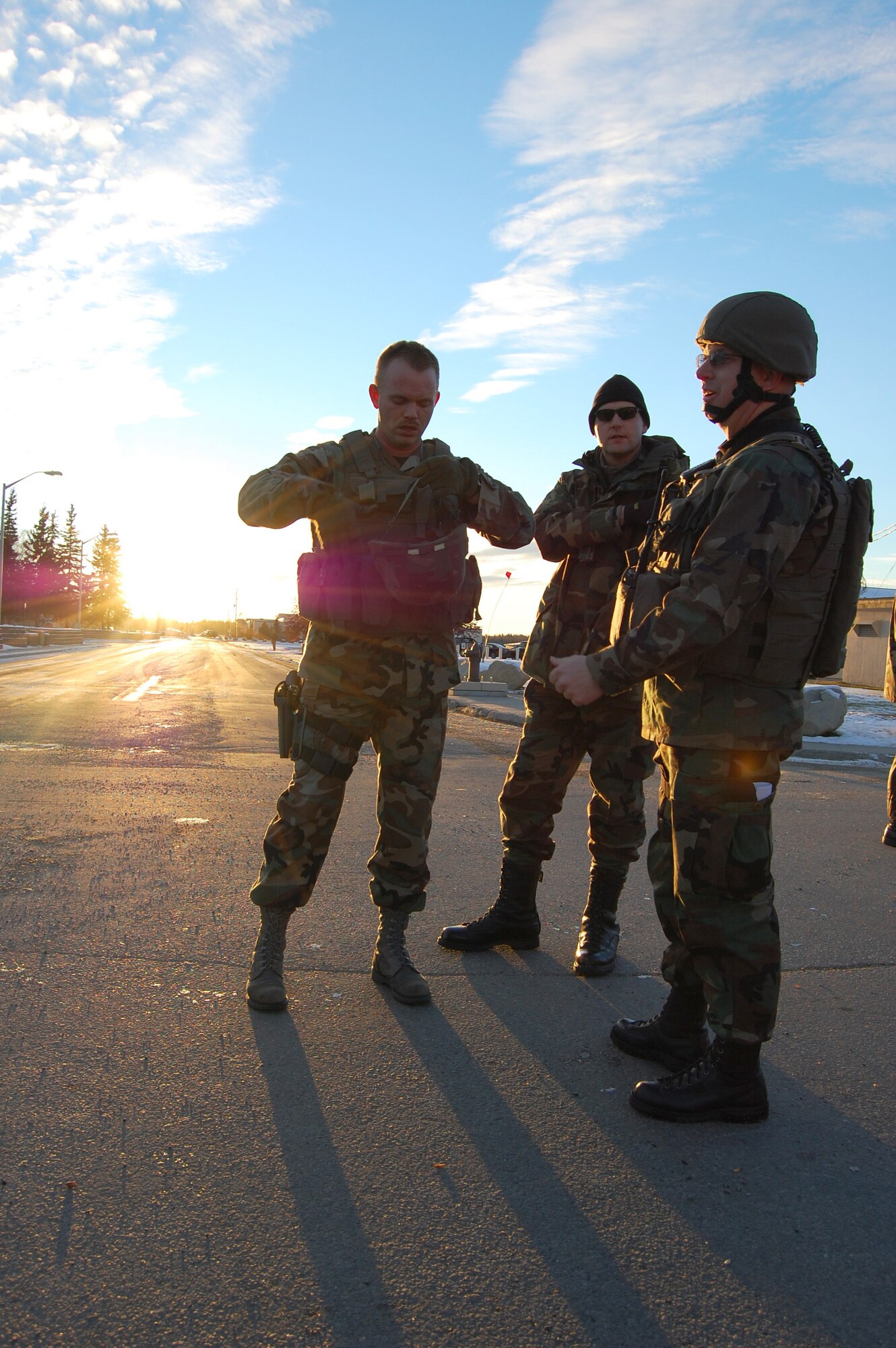 EIELSON AIR FORCE BASE, Alaska -- Staff Sgt. Justin Buchholz, 354th Security Forces Squadron, adjusts the chin strap on his helmet during a simulated bomb threat to Amber Hall Oct. 12, 2007. Eielson perfeormed an Operational Readiness Exercise Oct. 11 to 14, which contained a variety of scenarios and is employed to ensure Airmen are ready to mobilize at a moments notice when its nation calls. (U.S. Air Force photo by Airman 1st Class Christopher Griffin)
