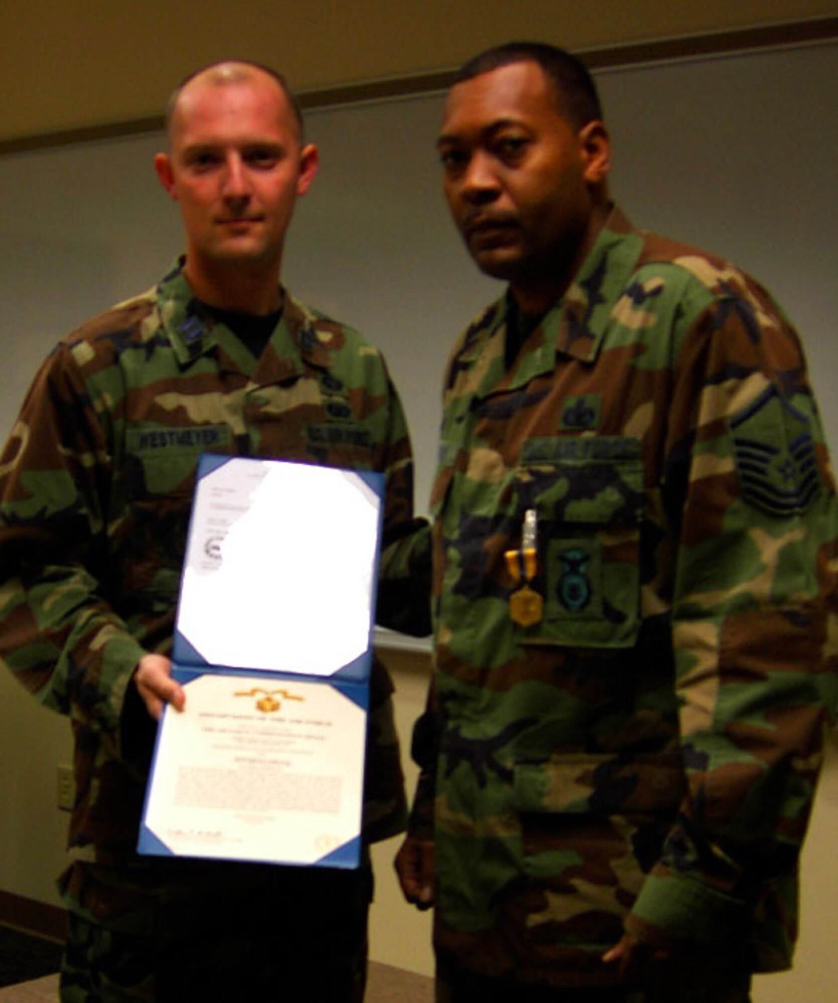 SEYMOUR JOHNSON AIR FORCE BASE, N.C.--Master Sgt. Carl Wiggins (right) receives the Air Force Commendation Medal from Capt. Jason Westmeyer for his exceptional performance while assigned to the 913th Airlift Wing at Willow Grove, Penn. Sgt. Wiggins is now assigned to the 916th Air Refueling Wing Security Forces Squadron, Air Force Reserve.