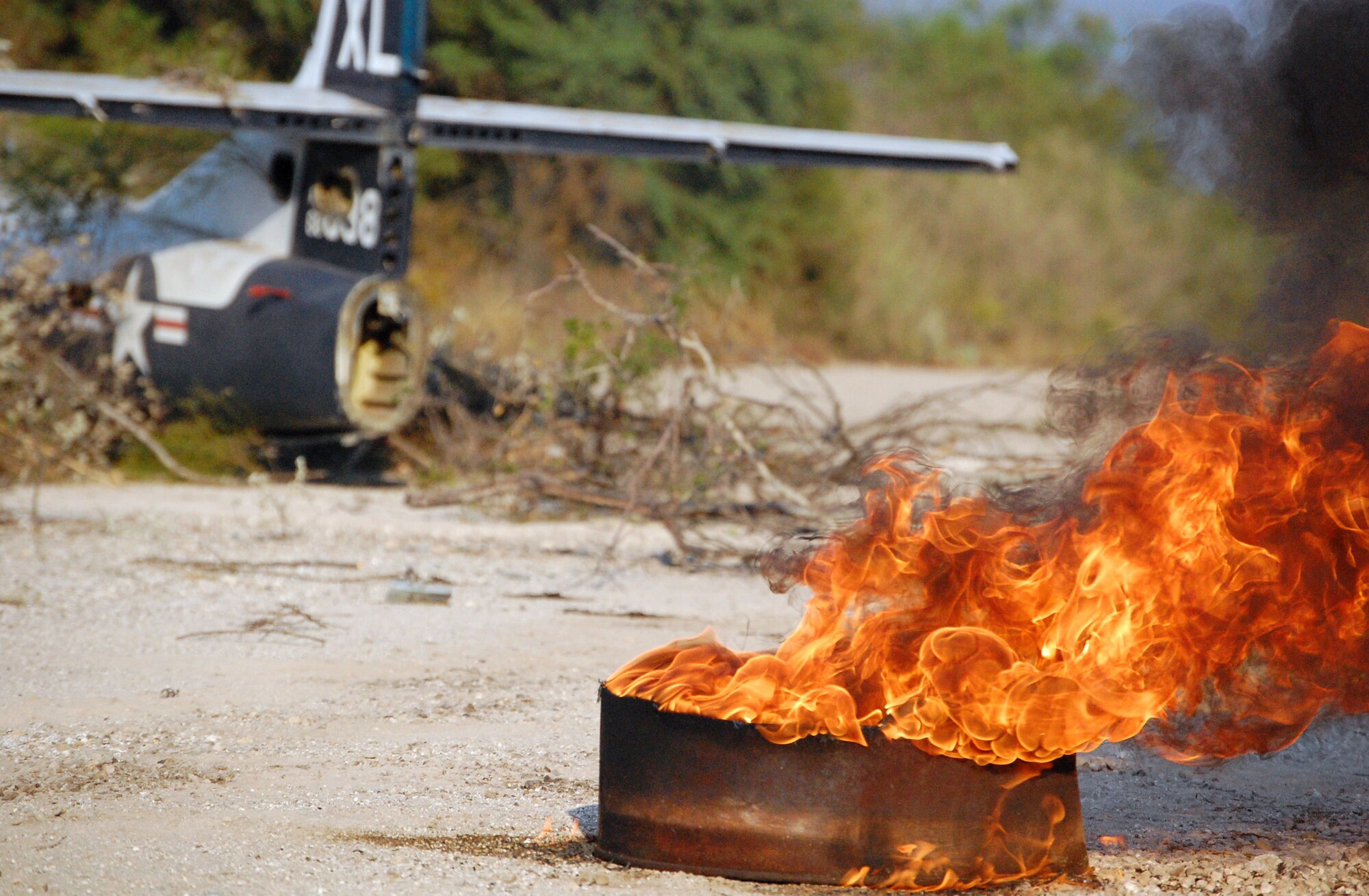 LAUGHLIN AIR FORCE BASE, Texas -- Small fires were lit just beyond the wreckage of the simulated T-6A II Texan crash scene during and joint exercise between Laughlin and Del Rio Emergency Responders. The fires were ablaze for a short period of time before members of the Laughlin Fire Department showed up on scene and quickly extinguished the fires. (U.S. Air Force photo by Airman Sara Csurilla)
