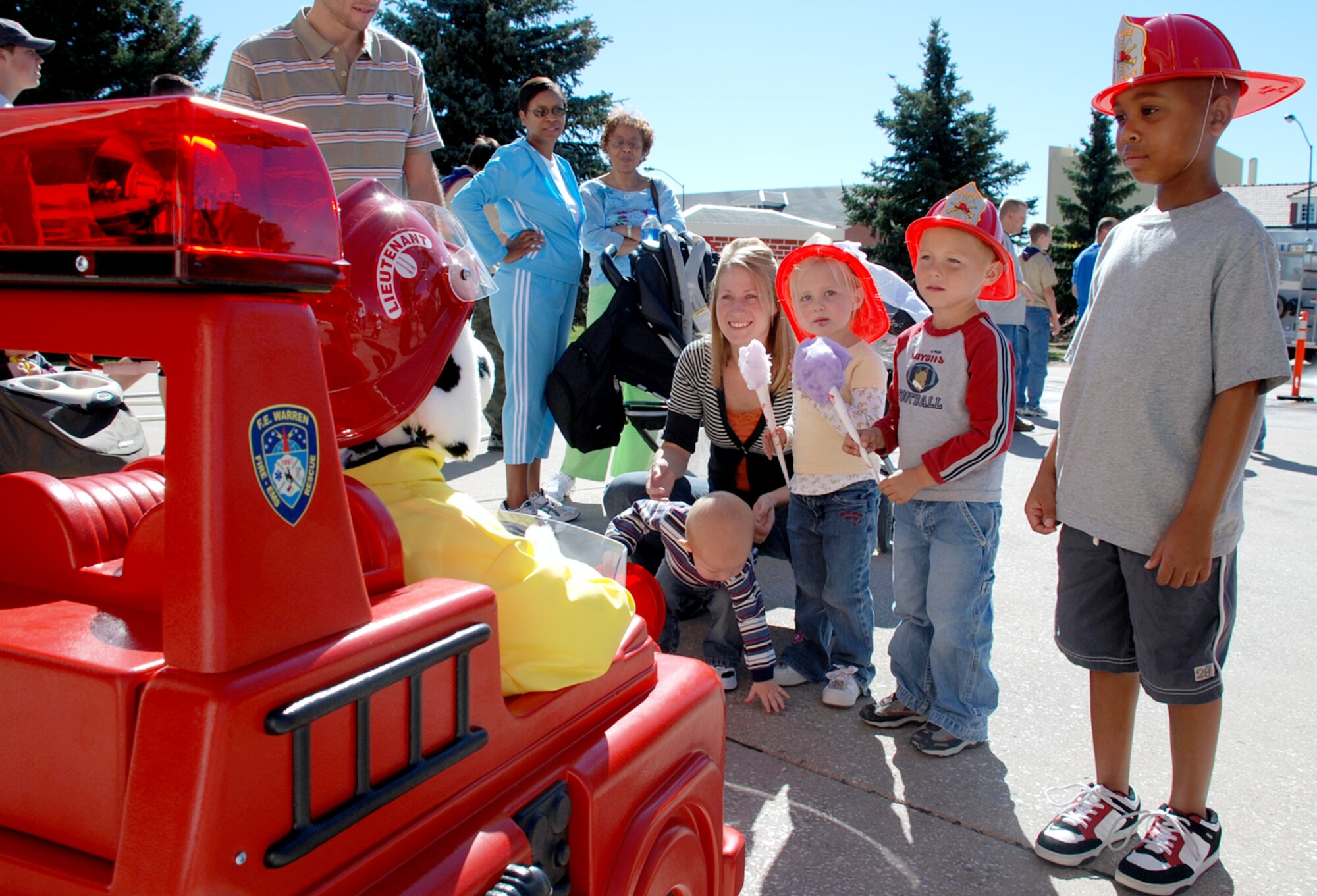 Children talk to Patches the fire dog as part of the fire prevention week open house. Brian Bartow, 90th Civil Engineer Squadron, operated the remote-controlled dog and could hear what the children were saying due to a two-way communication device (Photos by Airman 1st Class Daryl Knee).
