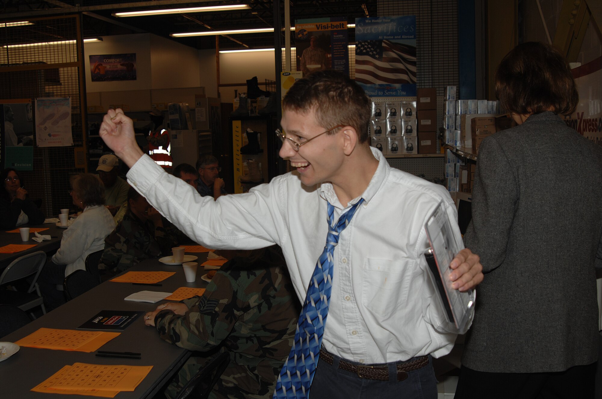 WHITEMAN AIR FORCE BASE, Mo. -- Brad Harrison, from the Johnson County Sheltered Workshop, enthusiastically collects his prize after winning "NDEAM" Bingo during a celebration of National Disability Employment Awareness Month Oct. 12. (U.S. Air Force photo/Senior Airman Lauren Padden)   