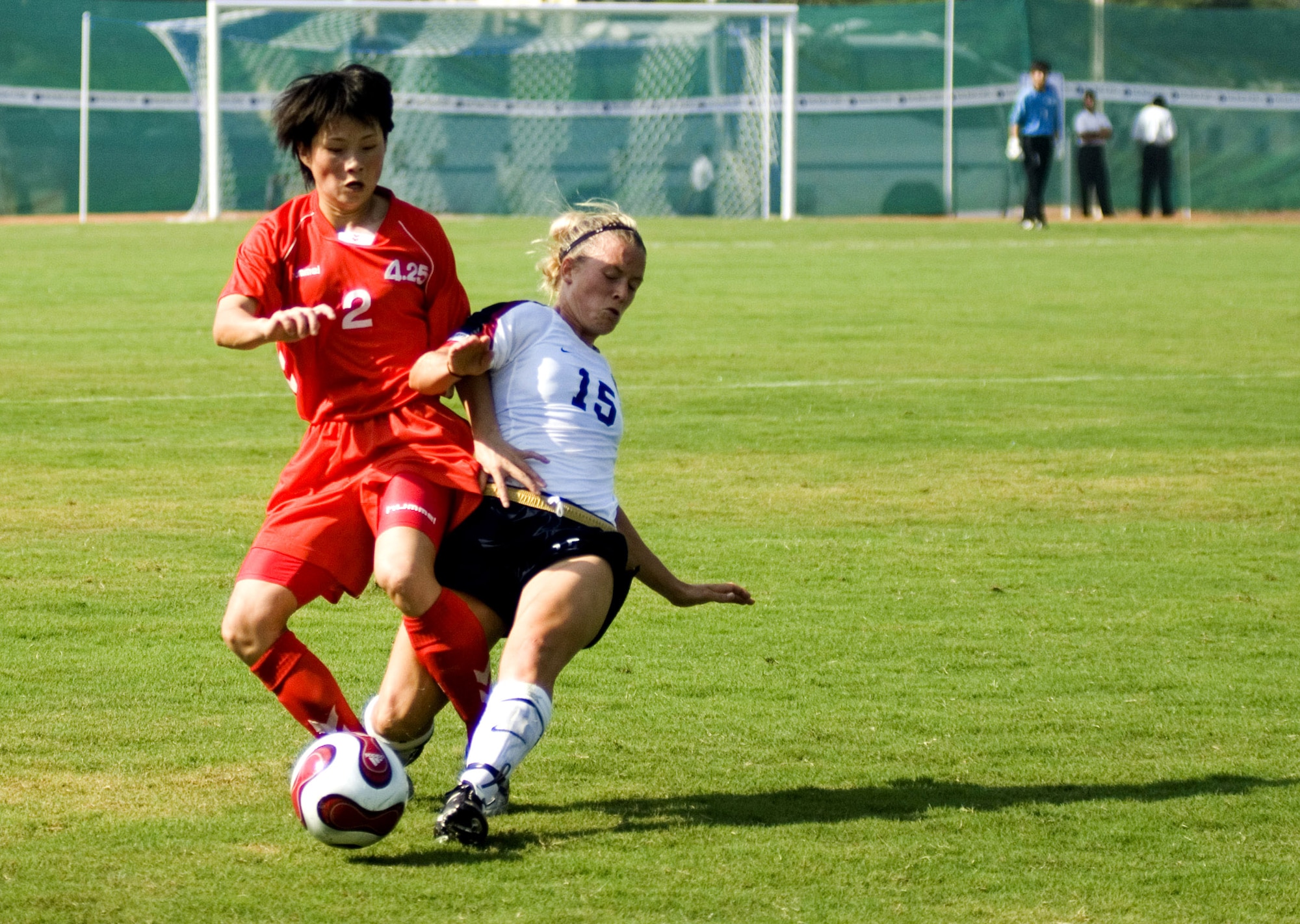 Second Lt. Yong Ok Jang from the Democratic Peoples Republic of Korea and U.S. Army Capt. Randee Farrell fight for possession of the ball during the Military World Games' first women's soccer match in Hyderabad, India, Oct. 14. DPR Korea defeated the U.S. team 4-0. The Conseil Internationale du Sport Militaire's Military World Games event is the largest international military Olympic-style event in the world. In this year's fourth edition of the games, 103 countries and more than 5,000 athletes are competing Oct. 14 to 21 in boxing, diving, soccer, handball, judo, military pentathlon, parachuting, sailing, shooting, swimming, volleyball and track and field. The purpose of the Military World Games is to promote "friendship through sport."  (U.S. Air Force photo/Tech. Sgt. Cecilio Ricardo Jr.) 