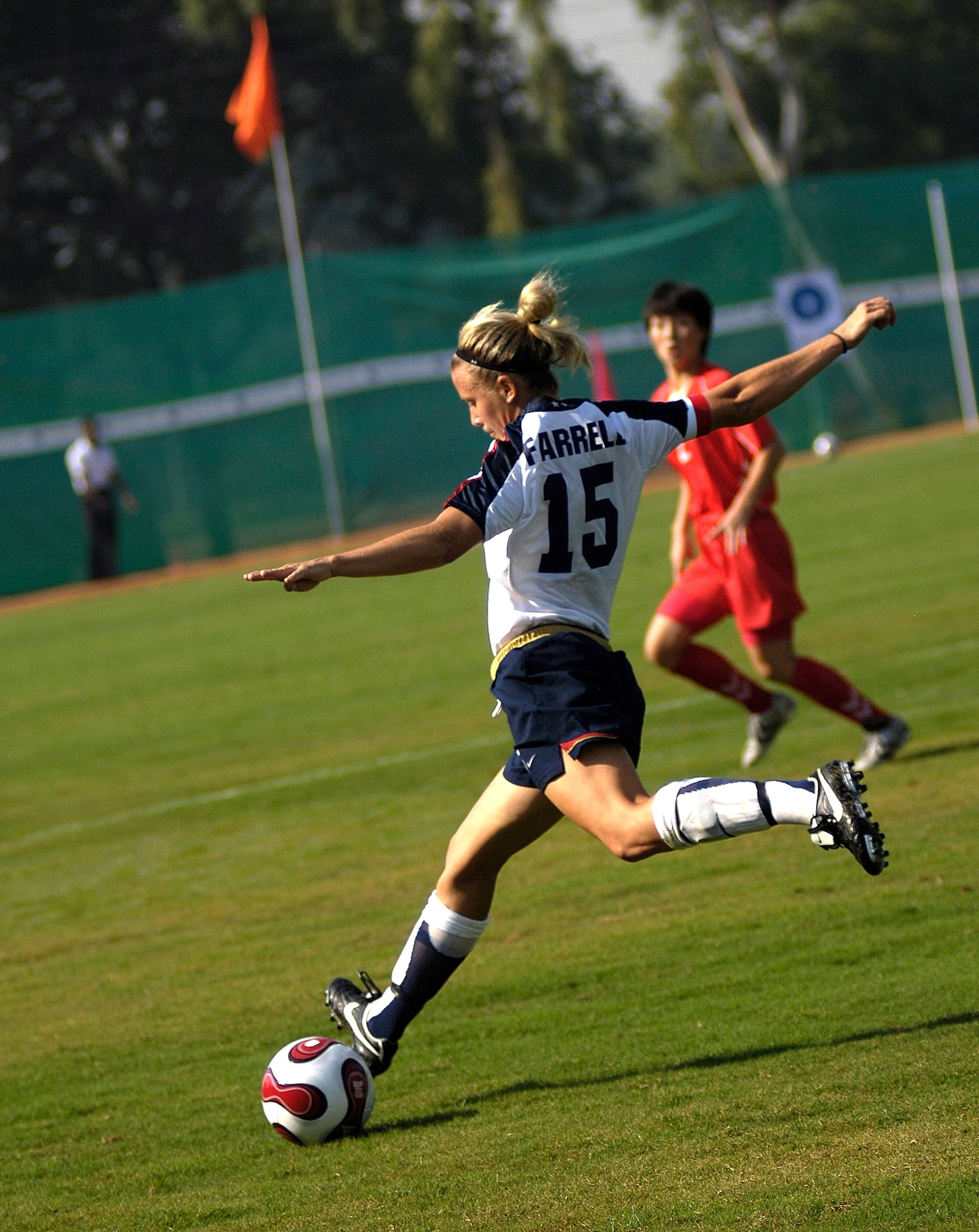 U.S. Army Capt. Randee Farrell, passes the ball as an opponent from the Democratic People's Republic of Korea moves in during the Military World Games' women's soccer competition in Hyderabad, India, Oct. 14. DPR Korea defeated the U.S. team 4-0. The Conseil Internationale du Sport Militaire's Military World Games event is the largest international military Olympic-style event in the world.  In this year's fourth edition of the games, 103 countries and more than 5,000 athletes are competing Oct. 14 to 21 in boxing, diving, soccer, handball, judo, military pentathlon, parachuting, sailing, shooting, swimming, volleyball and track and field. The purpose of the Military World Games is to promote "friendship through sport."  (U.S. Air Force photo/Tech. Sgt. Cecilio Ricardo Jr.) 