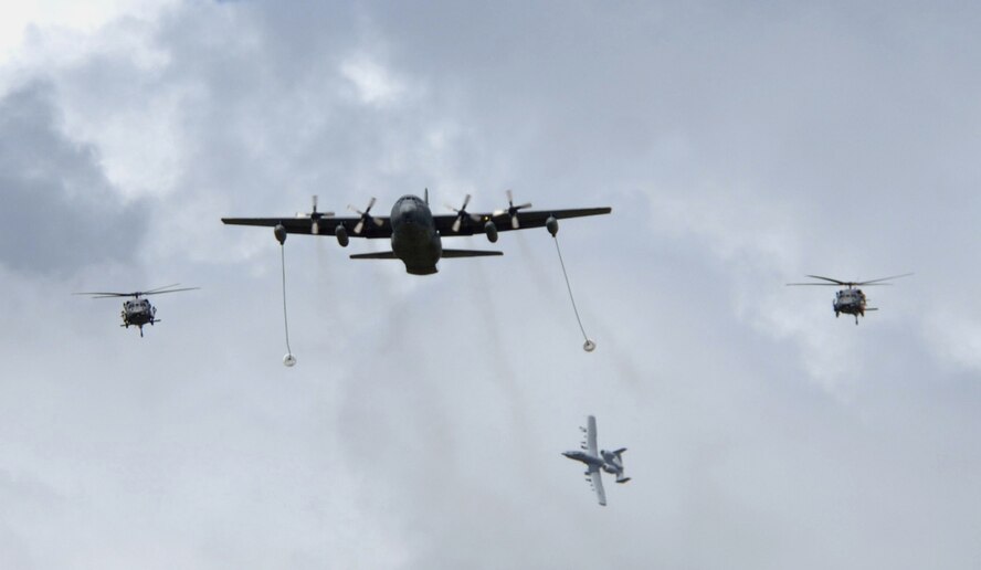 Two HH-60G Pave Hawks, an A-10C Thunderbolt and a C-130P fly over Moody skies during a Combat Search and Rescue Airpower demonstration Oct. 5. These three aircraft types will combine assets once again to perform two CSAR demonstrations during Moody's upcoming airfest Oct 20-21. (U.S. Air Force photo by Airman 1st Class Brittany Barker)