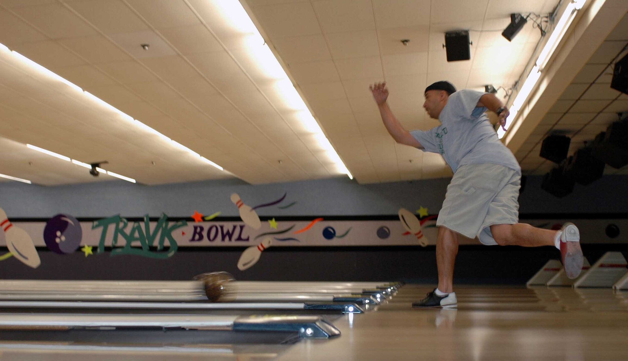 Dennis Flanary throws the ball down a Travis Bowling Center lane. The center’s also hosts 12 different bowling leagues where more than 300 bowlers participate. (U.S. Air Force photo/Nick DeCicco)