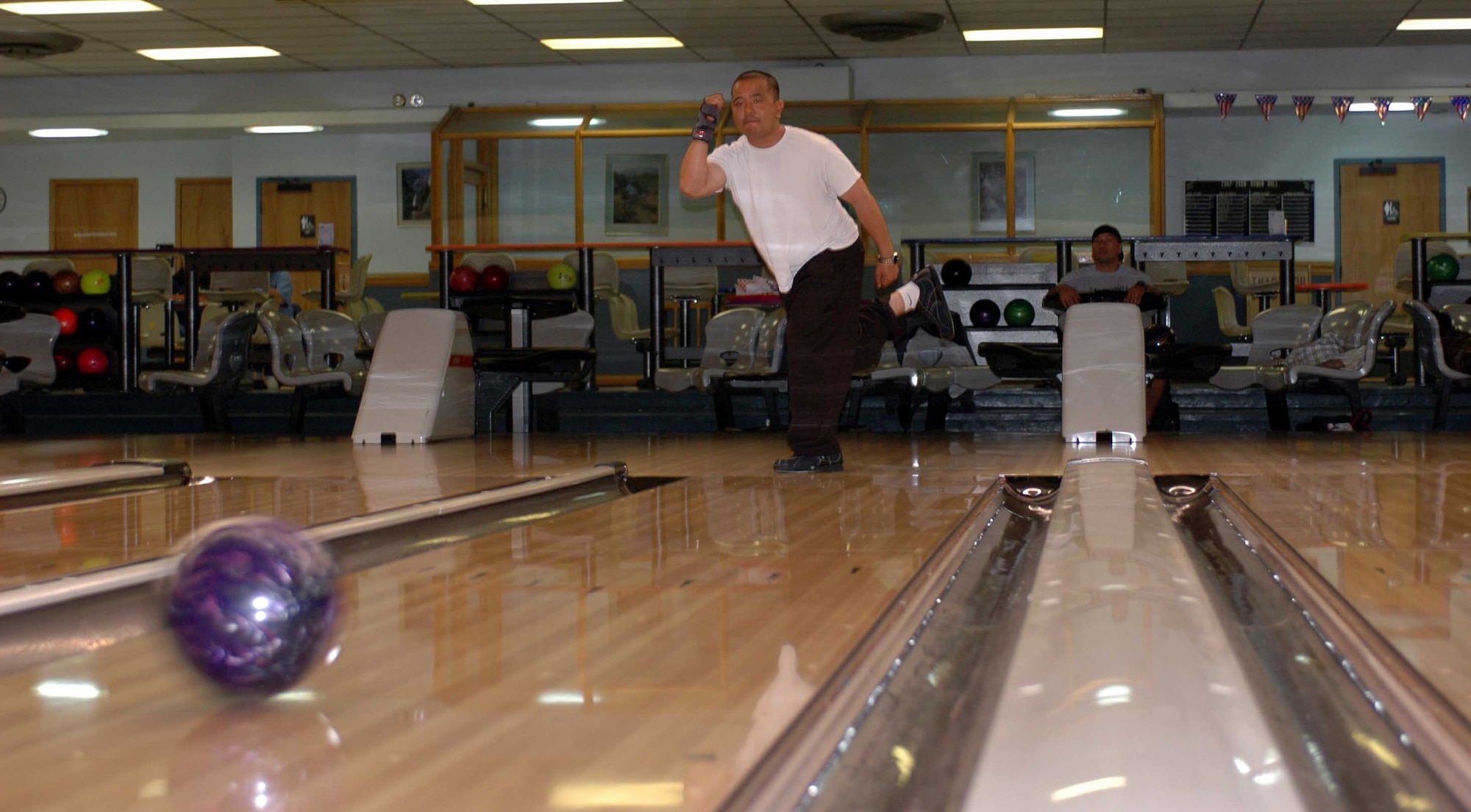 Charlie Alonga hurls his bowling ball down a lane at Travis Bowling Center. Travis’ Bowling Center has one of the highest number of lines, which are the number of individuals playing a game, in the Air Force. (U.S. Air Force photo/Nick DeCicco)