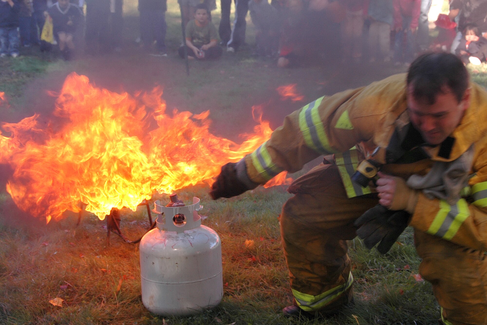 HANSCOM AFB, Mass. – A member of the Hanscom Fire Department ignites a fire in a camp skillet to demonstrate the dangerousness of fire and the precautions that should be taken to prevent fires. (U.S. Air Force photo by Dennis Lewis)