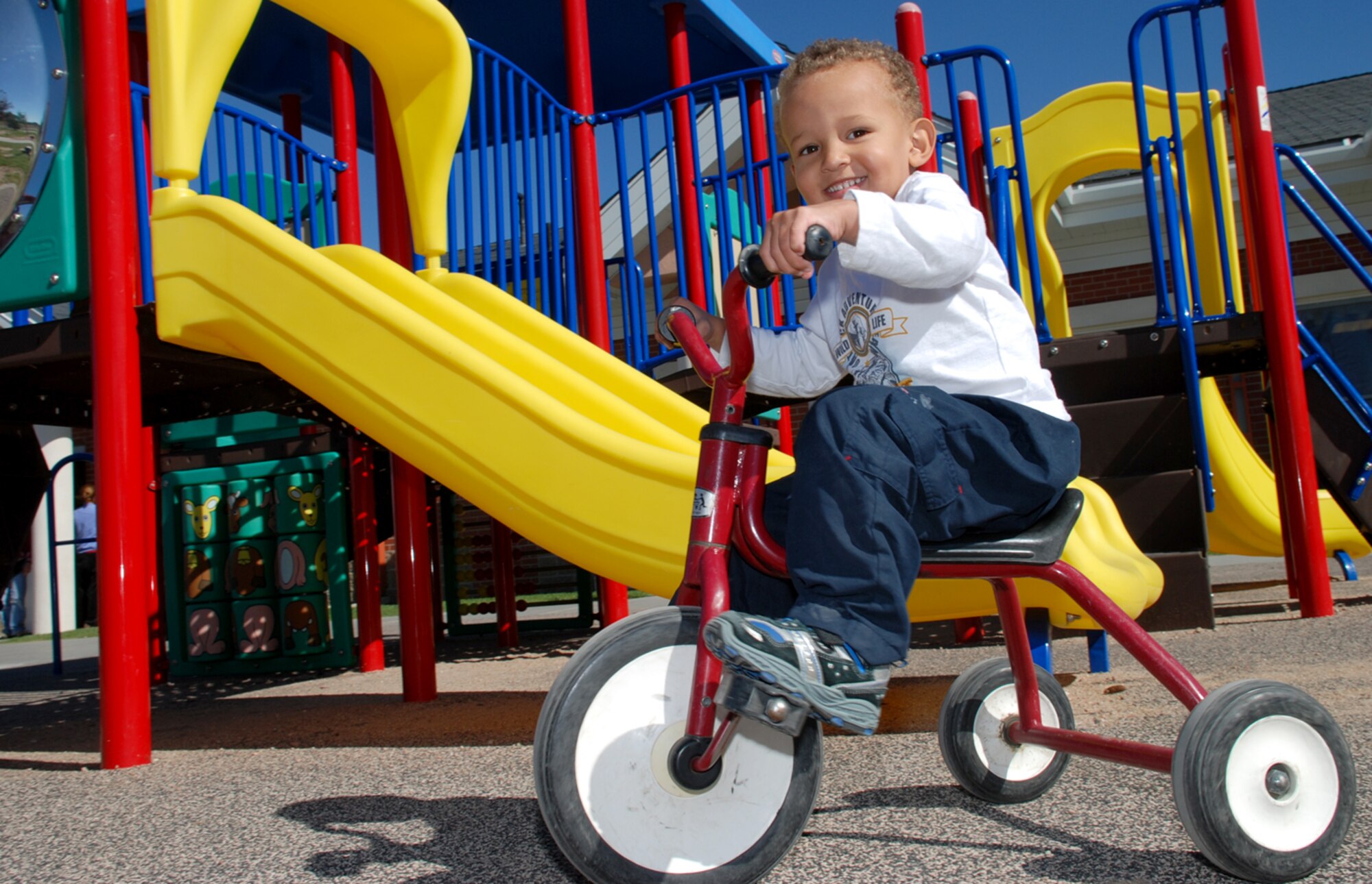 Athanase Lawless rides a tricycle for outside time at the Child Development Center here. Nicknamed ‘Nasey,’ Athanase is 3 years old and is in the toddler category at the newly accredited CDC (Photo by Airman 1st Class Daryl Knee).
