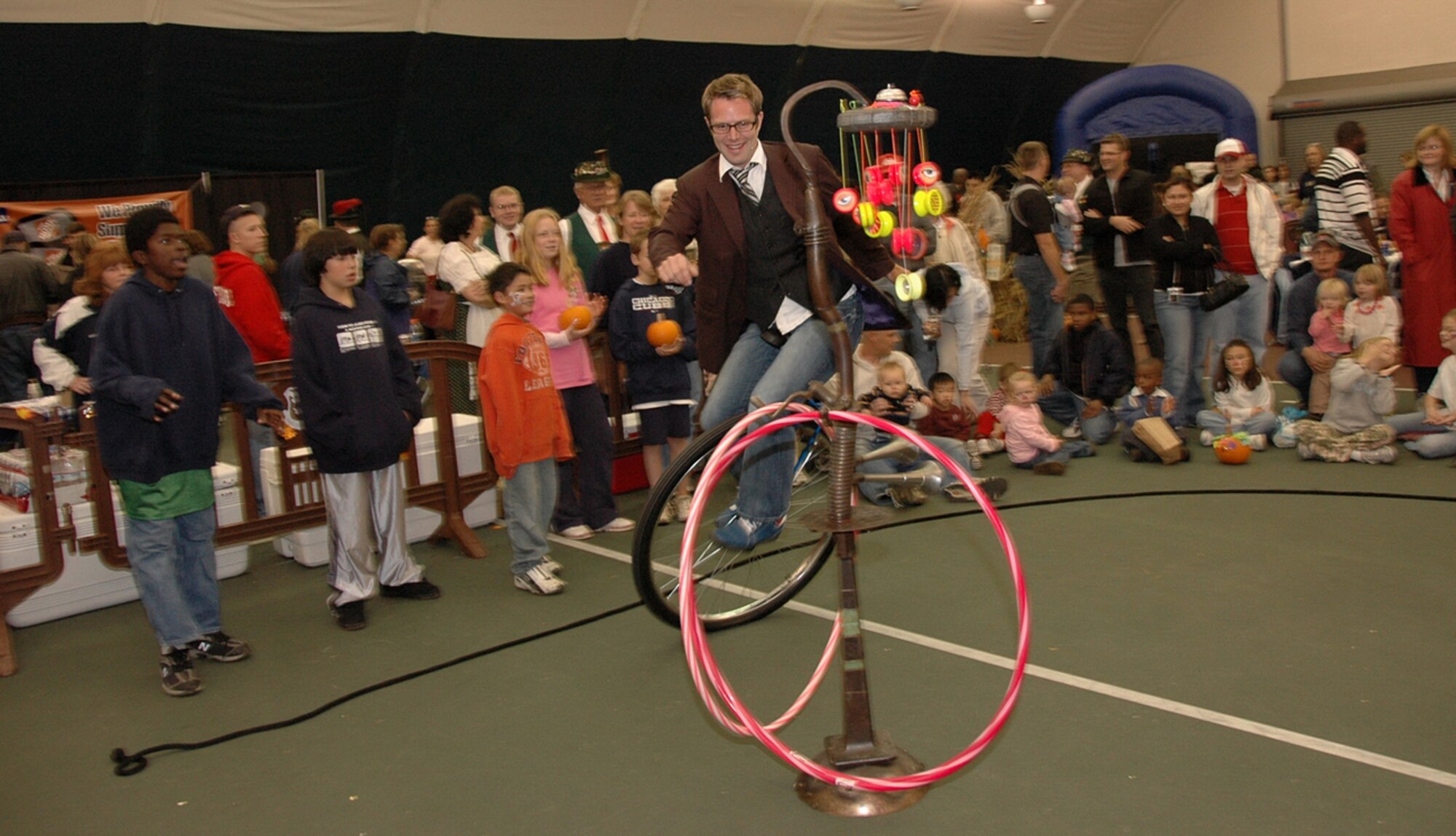 HANSCOM AFB, Mass. – John Higby a member of the duo, Yo Yo People, entertains the Oktoberfest crowd by riding his unicycle. (U.S. Air Force photo by Dennis Lewis)