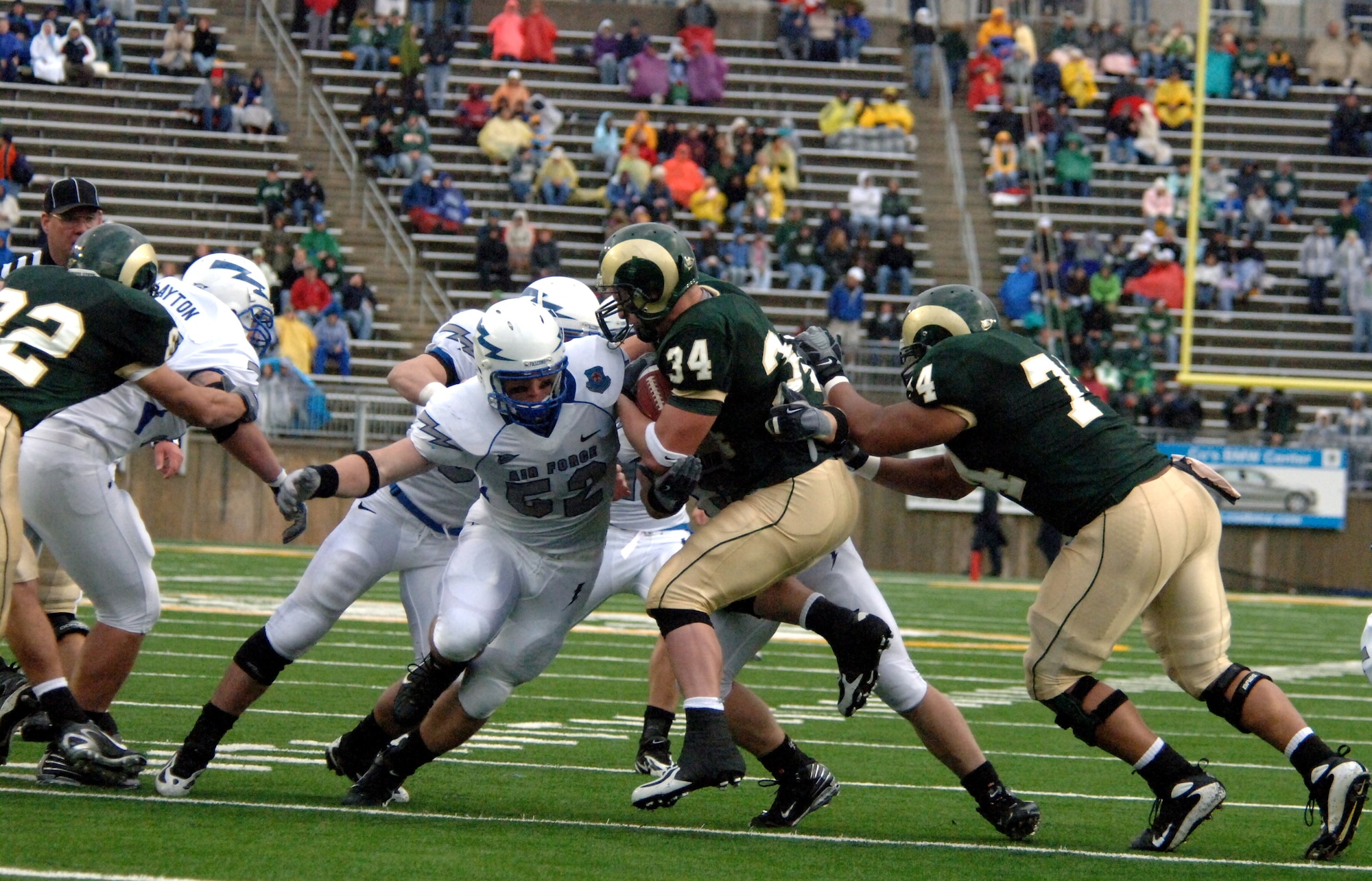 Falcon linebacker Austin Randle and company swarm Colorado State running back Kyle Bell during Air Force's 45-21 win over the Rams Oct. 13 in Fort Collins, Colo. The Falcon defense held CSU's leading rusher from 2006 to just 30 yards on eight carries. (U.S. Air Force photo/John VanWinkle)