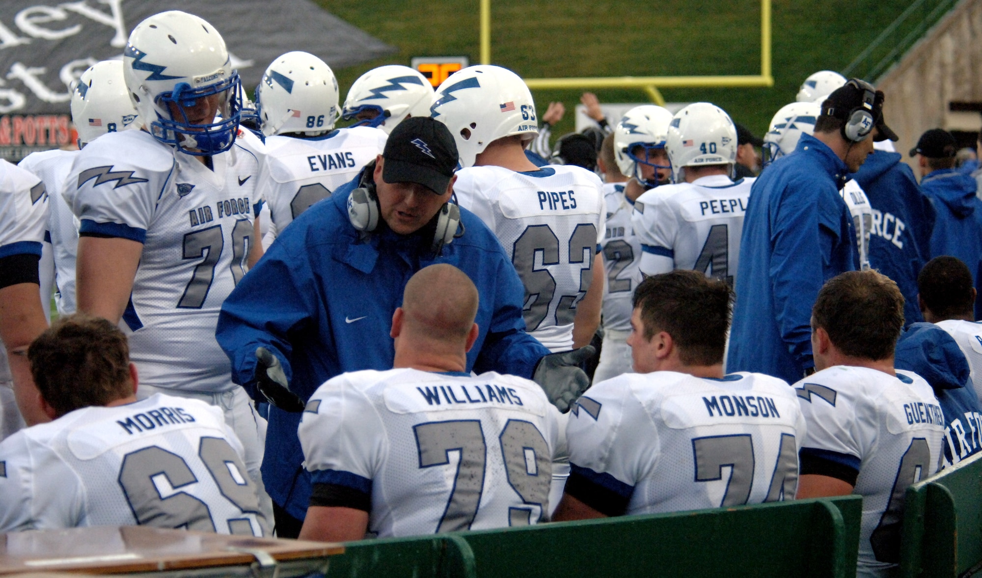 Air Force offensive line coach Clay Hendrix encourages his troops on the sideline during the Falcons' 45-21 win over the Colorado State Rams Oct. 13 at Fort Collins, Colo. The bluesuiters' O-line created holes for Air Force runners to total 385 yards on 69 carries. (U.S. Air Force photo/John Van Winkle)