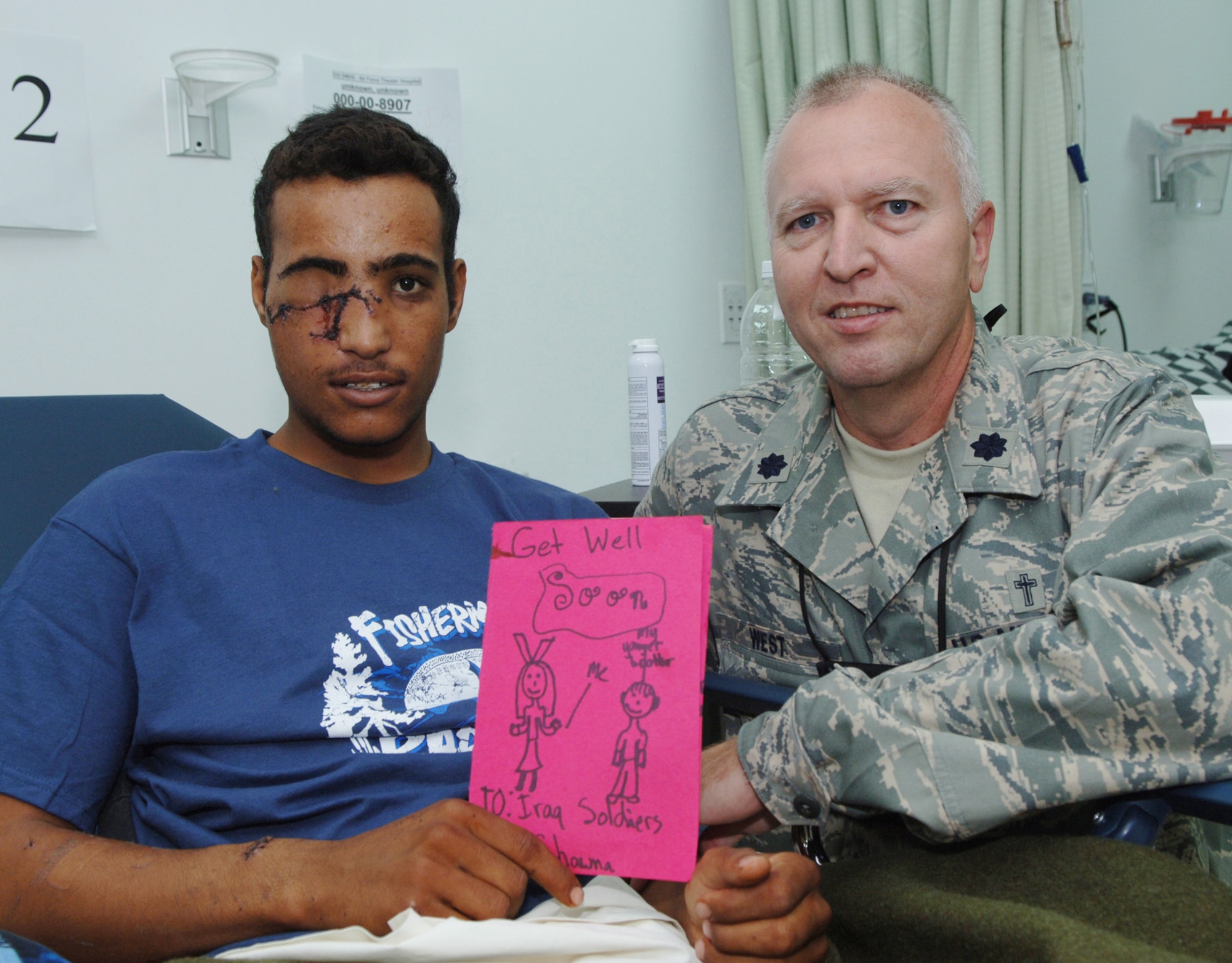 BALAD AIR BASE, Iraq -- Lt. Col. Steven West, 332nd Air Expeditionary Wing Chaplain, visits a wounded Iraqi soldier at the Air Force Theater Hospital here. The soldier received a letter from a little girl in United States. Colonel West and his staff at the hospital provide comfort and respond to the spiritual needs of coalition and Iraqi military members of all faiths, as well as civilians and others who are treated at the hospital. (U.S. Air Force photo/Tech. Sgt. D. Clare)