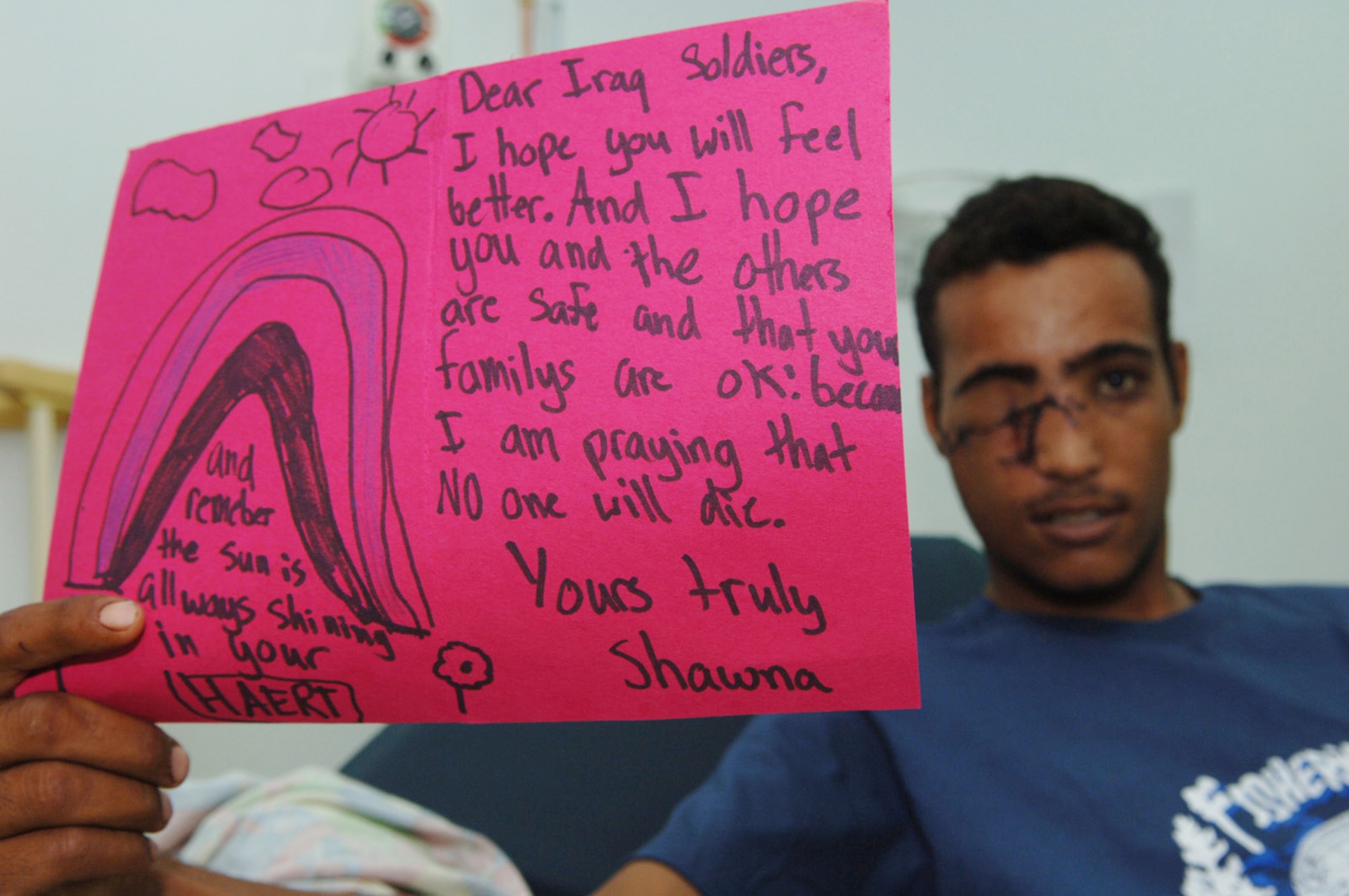 BALAD AIR BASE, Iraq -- A wounded Iraqi soldier at the Air Force Theater Hospital here, displays a greeting card he received from a little girl in the United States. The hospital provides full spectrum trauma and critical care for injured coalition forces, detainees and Iraqi civilians in the war. (U.S. Air Force photo by Technical Sgt. D. Clare)