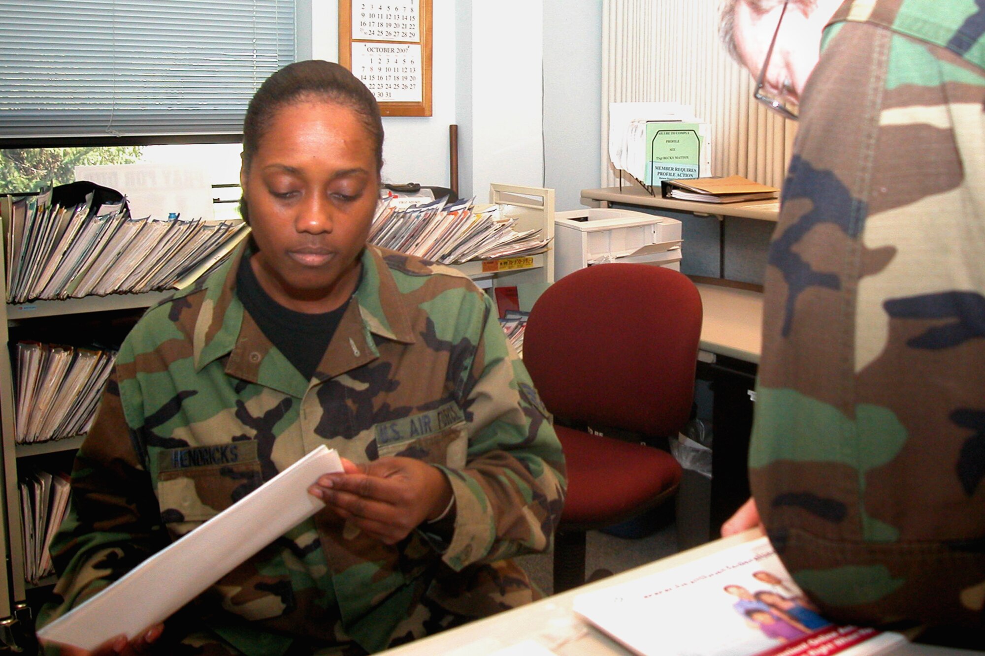 GRISSOM AIR RESERVE BASE, Ind., -- Senior Airman Lisa Hendricks, 434th Aerospace Medicine Squadron, assists a customer during a busy UTA morning.  The Grissom's clinic services up to 150 patients on a main UTA Saturday.   Grissom personnel can reduce their wait time physicals by completing their health risk assessment at least one month prior to their appointment.  (U.S. Air force photo/Senior Airman Chris Bolen)