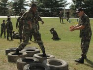 YOUNGSTOWN AIR RESERVE STATION, Ohio -- Air Force Reserve Tech. Sgt. Mike Woodall, a member of the 910th Maintenance Squadron, roots on an Air Force Junior Reserve Officer Training Corps (JROTC) cadet as she navigates an obstacle course here October 5.  Nearly 40 Air Force JROTC cadets from East and East Tech High Schools in Cleveland, and Green High School in Akron, Ohio received some military mentorship training during an AF JROTC Encampment.
Approximately 15 Air Force Reservists from the 910th Airlift Wing here volunteered their time during the five-day event to teach leadership skills, teamwork, respect for others and help improve the cadets' self-image.  U.S. Air Force Photo/Capt. Brent J. Davis
