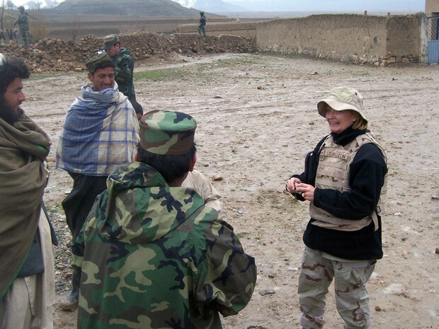 After speaking with local tribal elders, Senior Master Sgt. Linda Sturgeon, 315th Airlift Wing, Charleston AFB, S.C., and a team of volunteers from the National Military Academy of Afghanistan bring clothes and toys to the children there. (USAFR courtesy photo)  