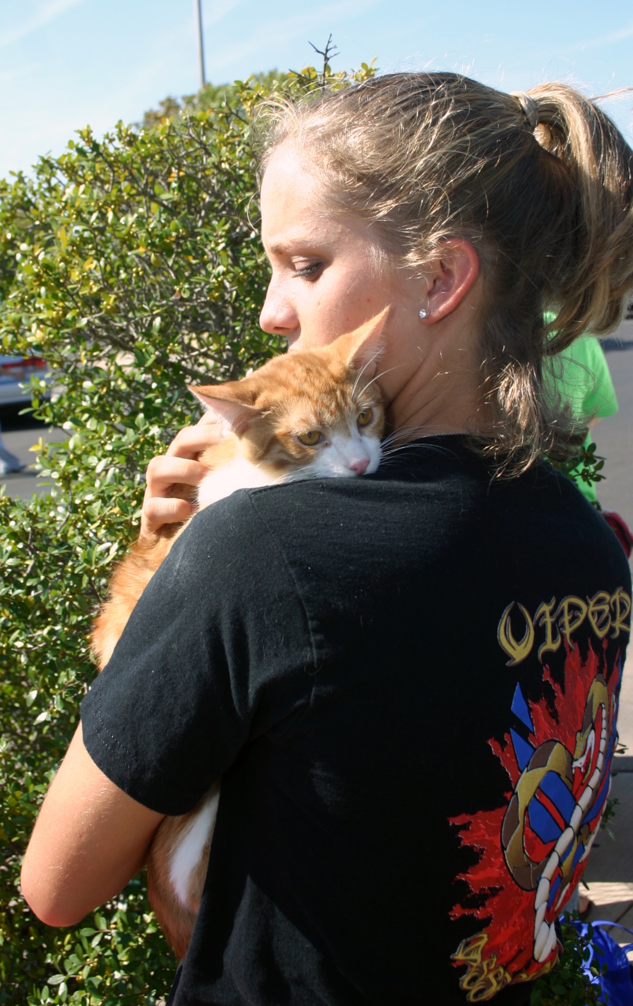 Airman Krista Rose of the 361st Training Squadron cuddles with Oliver, proving that animals of all types were welcome at the Dog Show in the base exchange parking lot Oct. 13. (U.S. Air Force photo/Staff Sgt. Tonnette Thompson)