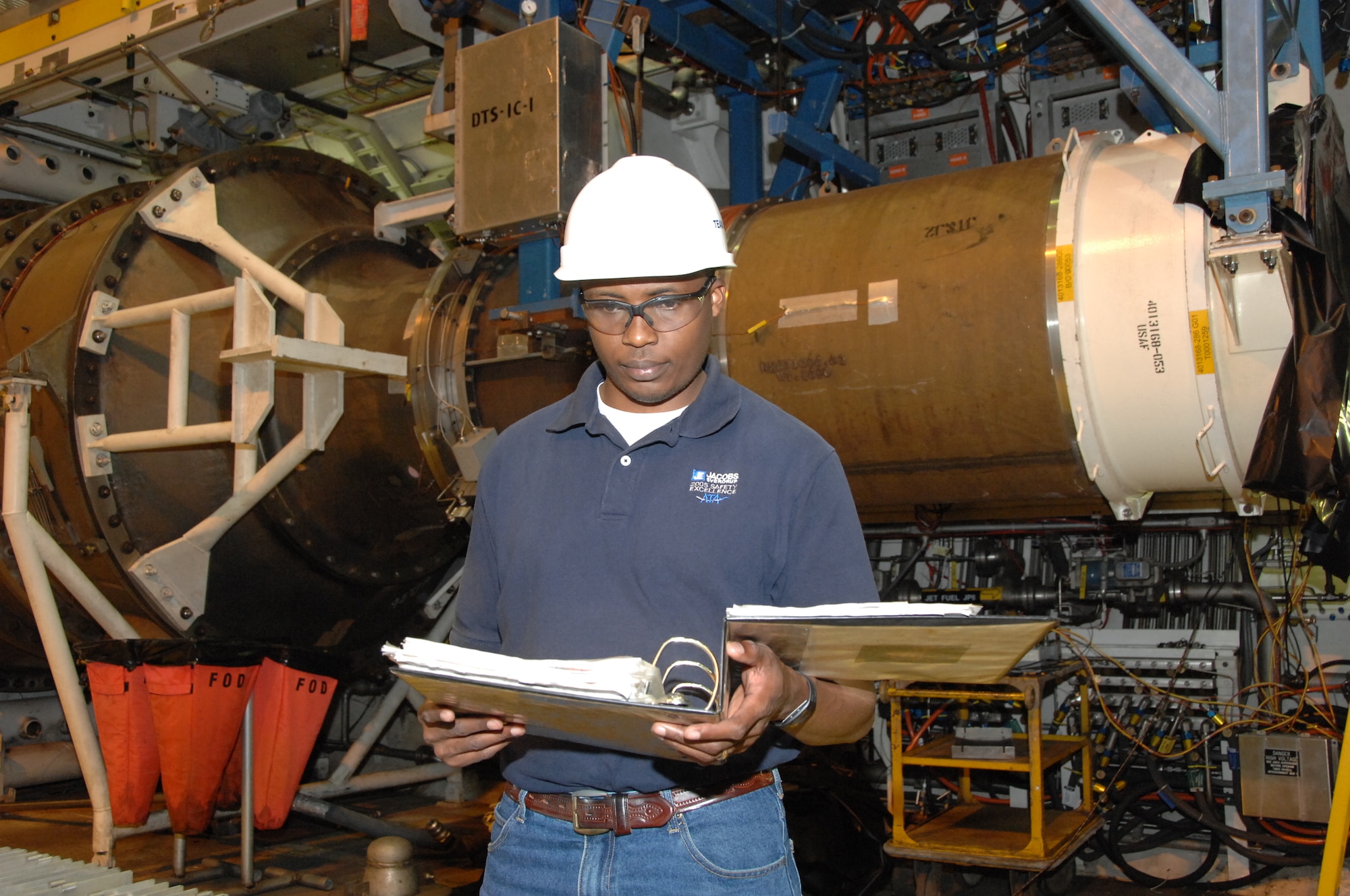 Jean Paul Mihigo, an Aerospace Testing Alliance data analysis engineer at Arnold Engineering Development Center, Arnold Air Force Base, Tenn., studies a test brief in the center’s J-1 engine test cell. (Photo by David Housch)