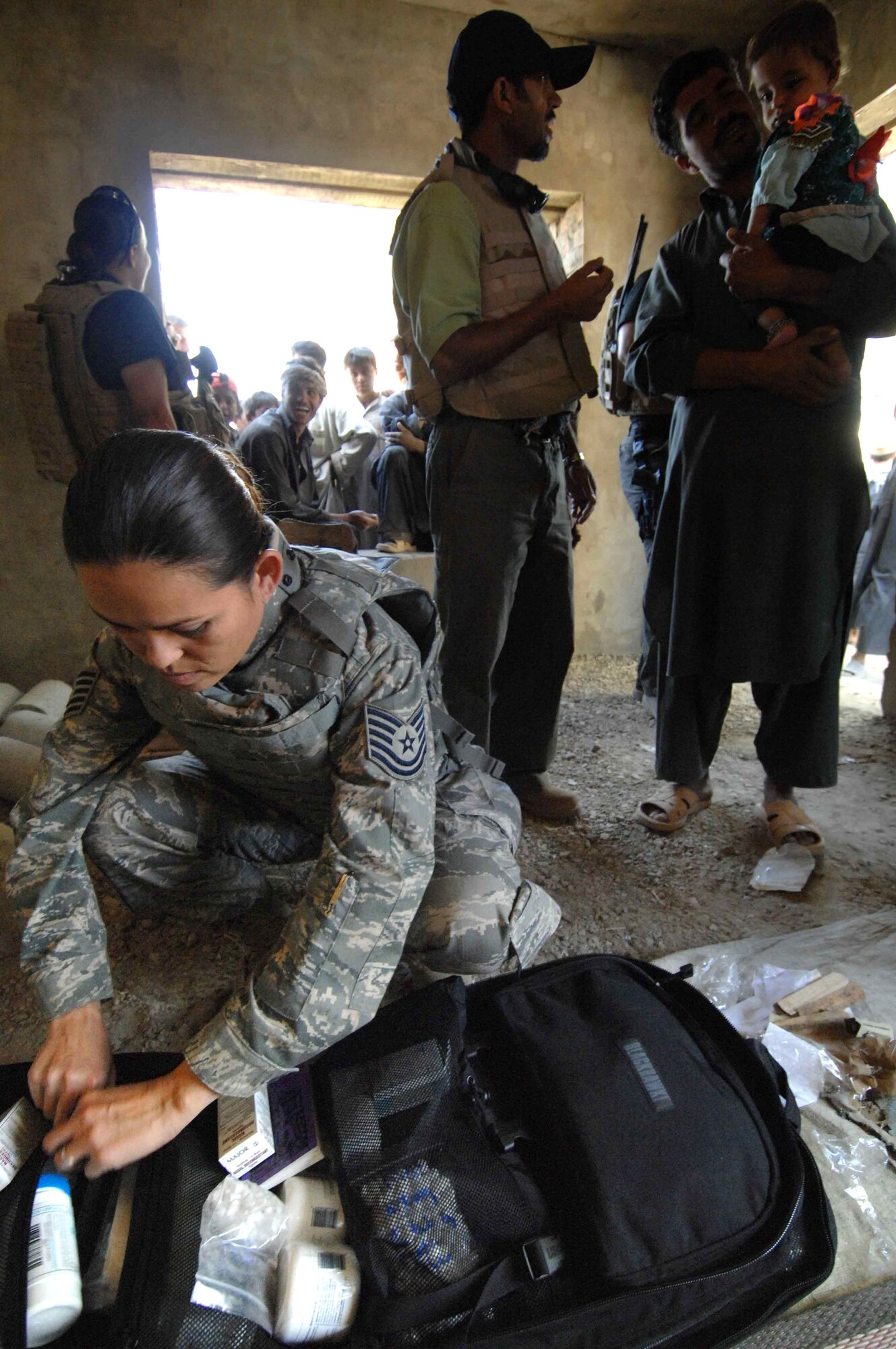 Tech. Sgt. Joy Flumerfelt checks her supplies Oct. 4 during a medical civil action project near Bagram Air Base, Afghanistan. Sergeant Flumerfelt is a medical technician with the 455th Air Expeditionary Wing. (U.S. Air Force photo/Staff Sgt. Joshua T. Jasper)