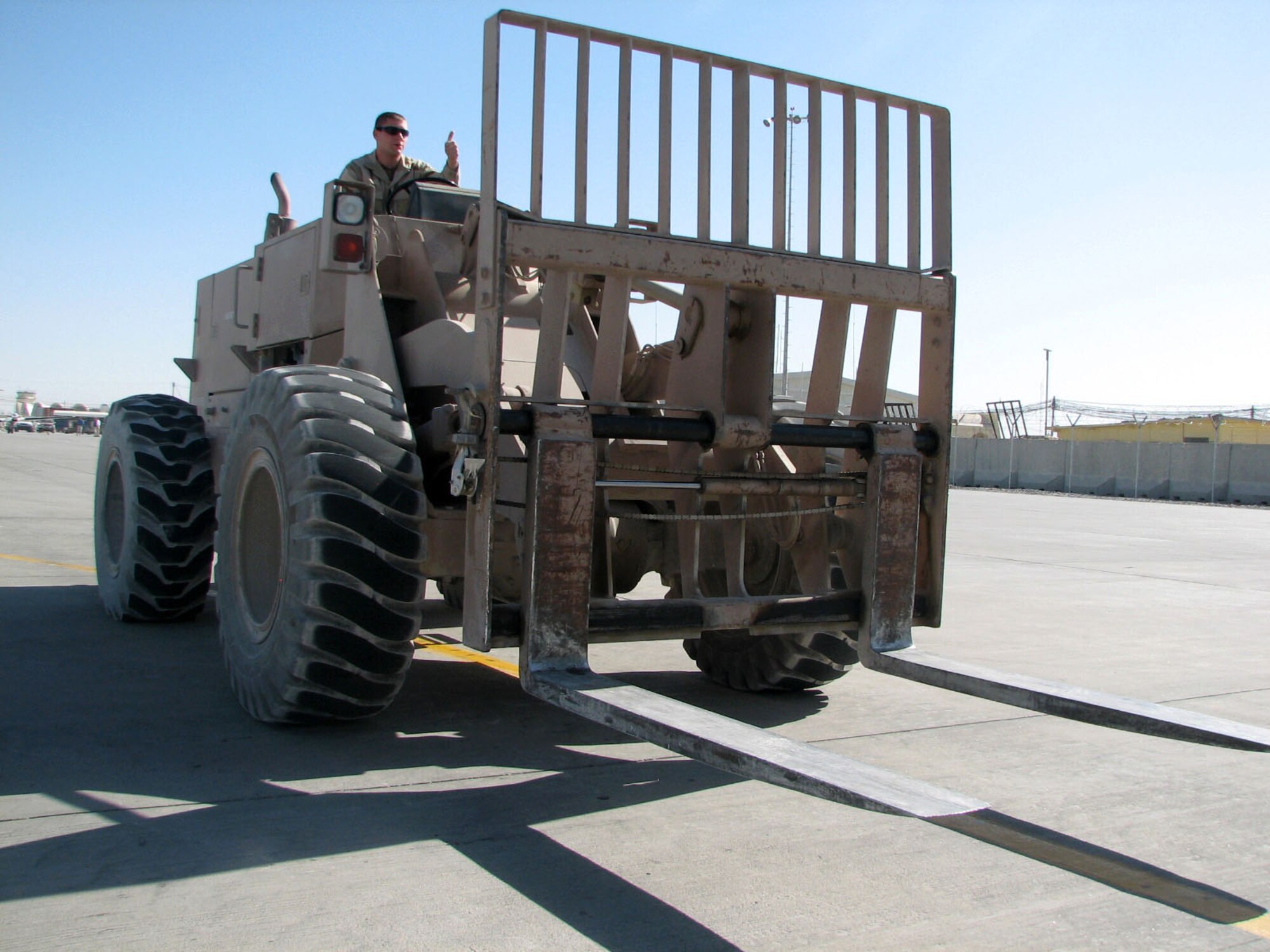 Airman 1st Class James Nalley prepares to offload cargo from a C-130 Hercules Oct. 12 at Kandahar Airfield, Afghanistan. Airman Garcia is a member of the 455th Air Expeditionary Wing, whose mission is to provide close-air support, mobility, intelligence, surveillance and reconnaissance in support of the war on terrorism. (U.S. Air Force photo/Capt. Michael Meridith)