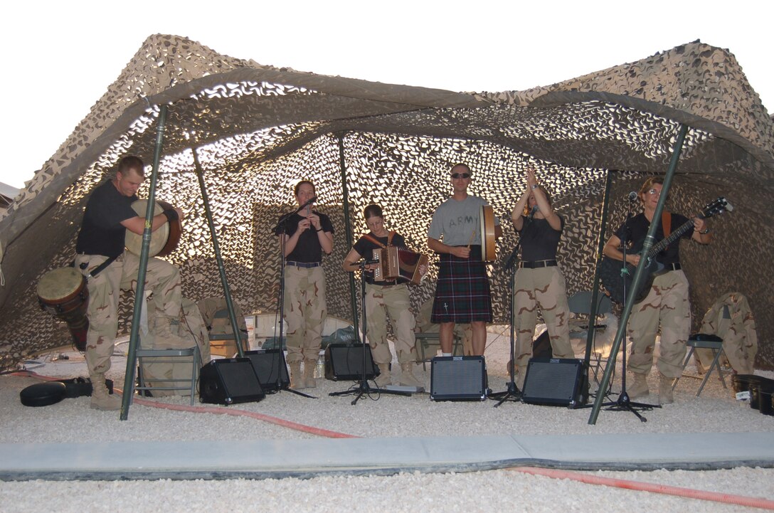 (L-R) Airman 1st Class Brandon Richard (Percussion), Airman 1st Class Amy McCann (Whistle), Staff Sergeant Lacey Stokes (Accordion), Technical Sergeant Sherry Burt (Flute) and Technical Sergeant Gail Adams (Guitar) of the USAF Heritage of America Band's Heritage Aire Celtic music ensemble are joined by an Army chaplain and proud Scotsman while on post in southwest Asia.  Heritage Aire is currently on deployment with the US Central Command Air Force (CENTAF) Band's Desert Ramblers.