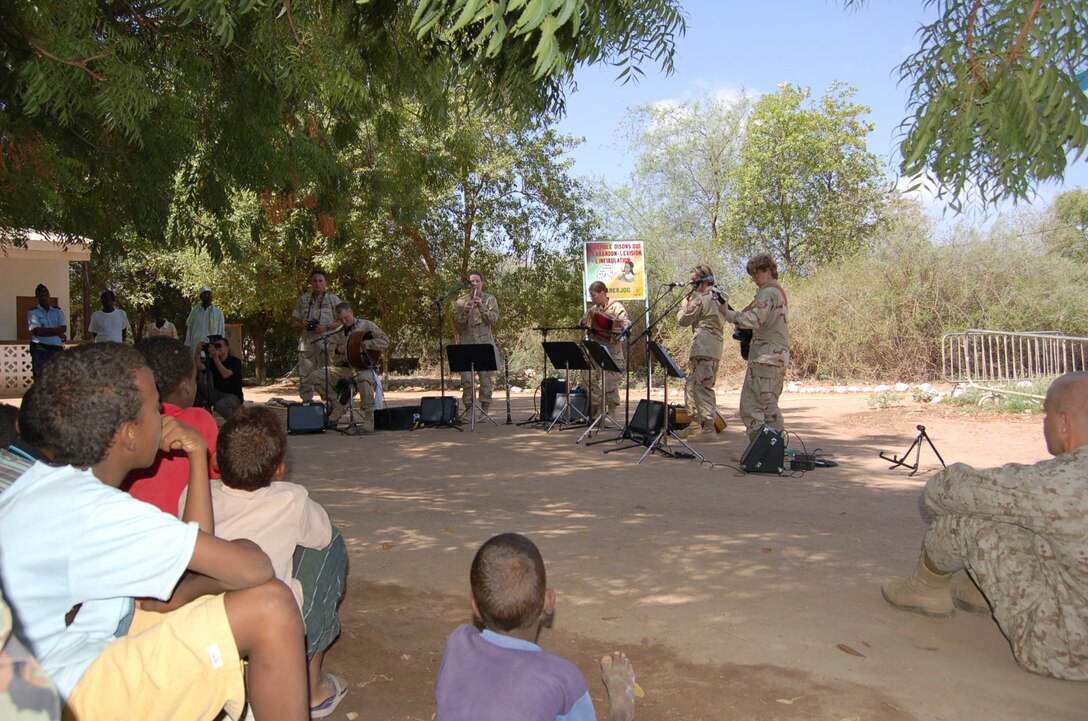 (L-R) Airman 1st Class Brandon Richard (Bodhran), Airman 1st Class Amy McCann (Whistle), Staff Sergeant Lacey Stokes (Accordion), Technical Sergeant Sherry Burt(Flute) and Technical Sergeant Gail Adams (Guitar) of the USAF Heritage of America Band's Heritage Aire Celtic music ensemble perform for local residents of Damerjog, Djibouti while on deployment with the US Central Command Air Force (CENTAF) Band's Desert Ramblers.