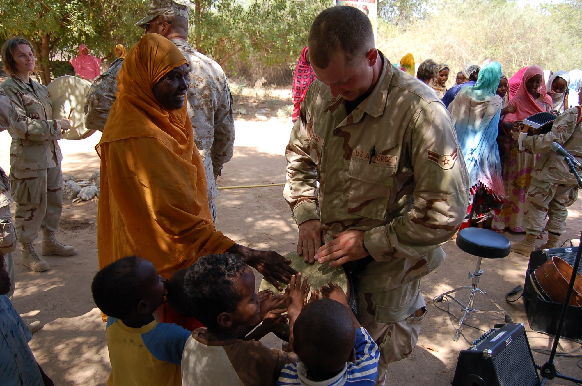 Airman 1st Class Brandon Richard of the USAF Heritage of America Band's Heritage Aire Celtic music ensemble meets some of the local residents of Damerjog, Djibouti while on deployment with the US Central Command Air Force (CENTAF) Band's Desert Ramblers.