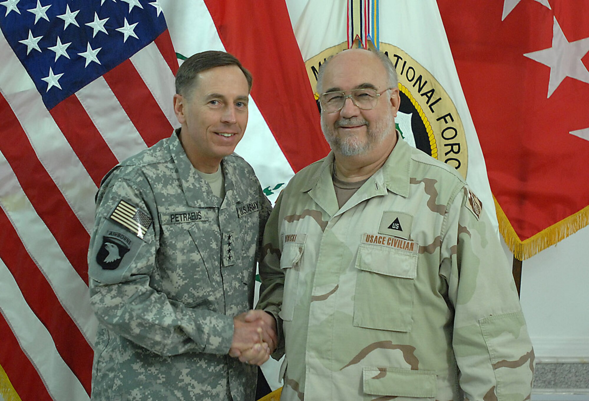 SOUTHWEST ASIA -- Multi-National Force -- Iraq Commander Gen. David Petraeus shakes the hand of Contracting Officer Roger Nowicki. Mr. Nowicki, a civilian employee assigned to the 66th Contracting Squadron at Hanscom, volunteered for a year-long deployment to Southwest Asia. There he has processed numerous contracts including some to construct a Press Conference Center, which the general will use. The construction is one-and-a-half months ahead of schedule and $200,000 under budget. Mr. Nowicki is scheduled to return to Hanscom later this month.
