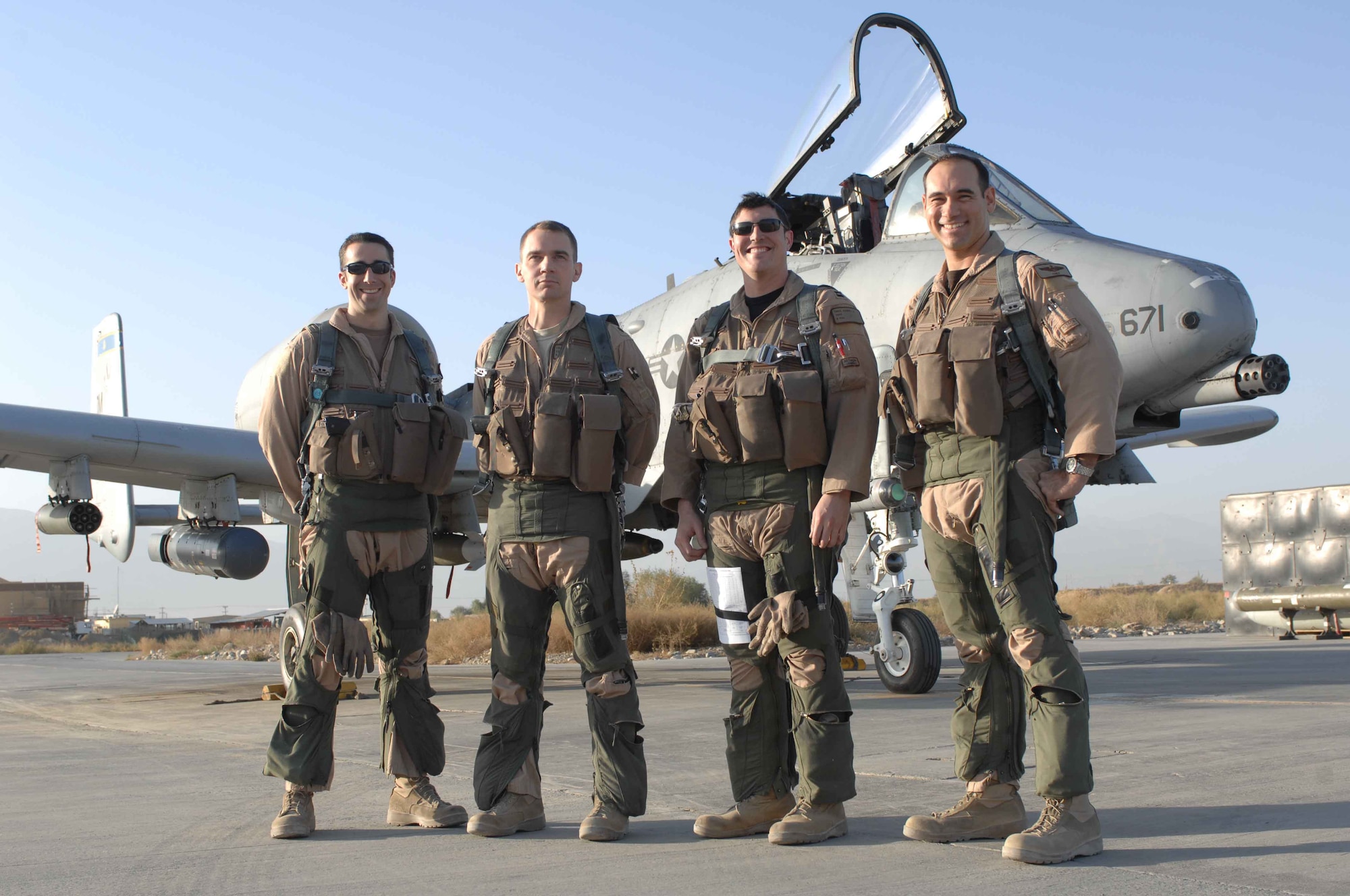 BAGRAM AIRFIELD, Afghanistan -- Four A-10 Thunderbolt II pilots with the 354th Expeditionary Fighter Squadron here recently achieved a milestone 100 combat sorties:  (from left to right) Capt Ryan Cleveland, exchange pilot Navy Lt. Cmdr. Scott Craig, Capt. Daniel Cruz and Maj. James Barlow. (U.S. Air Force Photo by Staff Sgt. Joshua Jasper)
