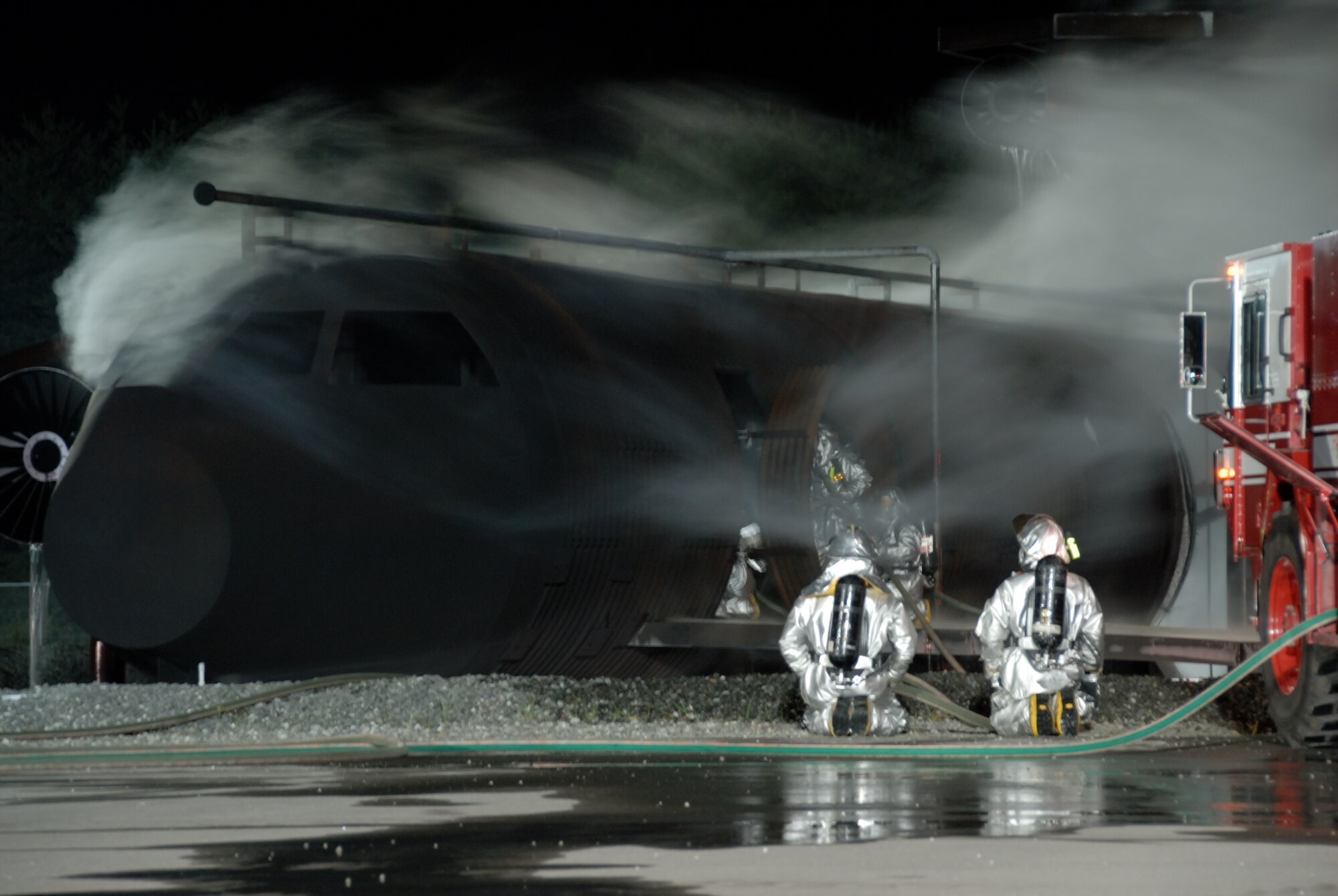 MISAWA AIR BASE, Japan -- Fire fighters from the 35th Civil Engineering Squadron successfully put out a blaze on an aircraft fire trainer during fire prevention week here on Oct. 9, 2007.  The 35th Civil Engineering Squadron annually demonstrates fire fighting procedures for Misawa residents.  (U.S. Air Force photo by Senior Airman Laura R. McFarlane)(RELEASED)