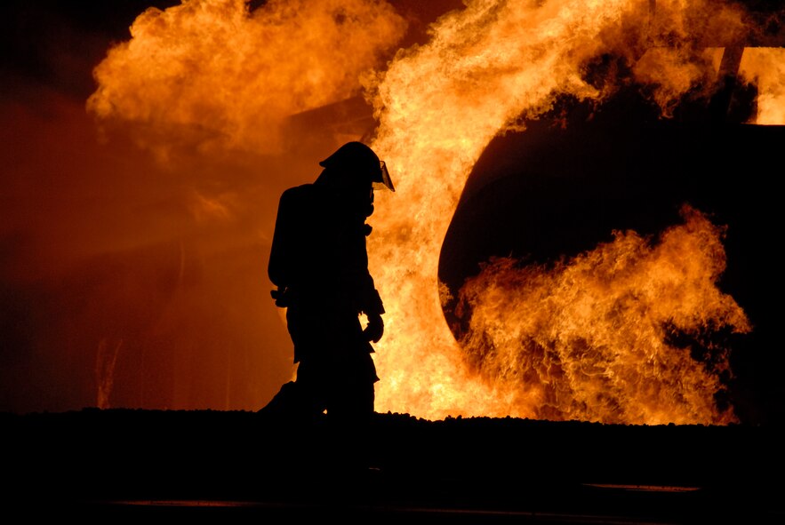 MISAWA AIR BASE, Japan-- A fire fighter from the 35th Civil Engineering Squadron works to put out a blaze on an aircraft fire trainer during fire prevention week here on Oct. 9, 2007.  The 35th Civil Engineering Squadron annually demonstrates fire fighting procedures for Misawa residents.  (U.S. Air Force photo by Senior Airman Laura R. McFarlane)(RELEASED)