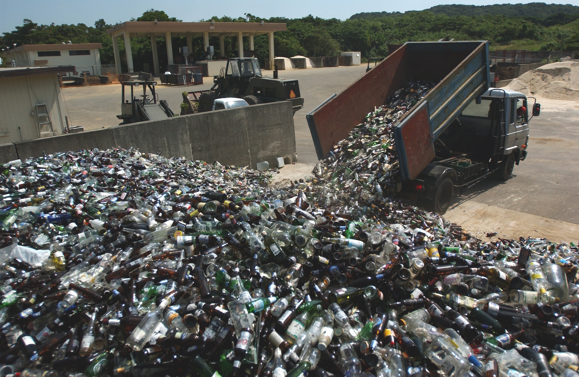 Hamamura Takemitsu, from the Onna Chikusan company, dumps recycled glass collected from the housing areas on base.
(U.S. Air Force photo/Tech. Sgt. Rey Ramon)